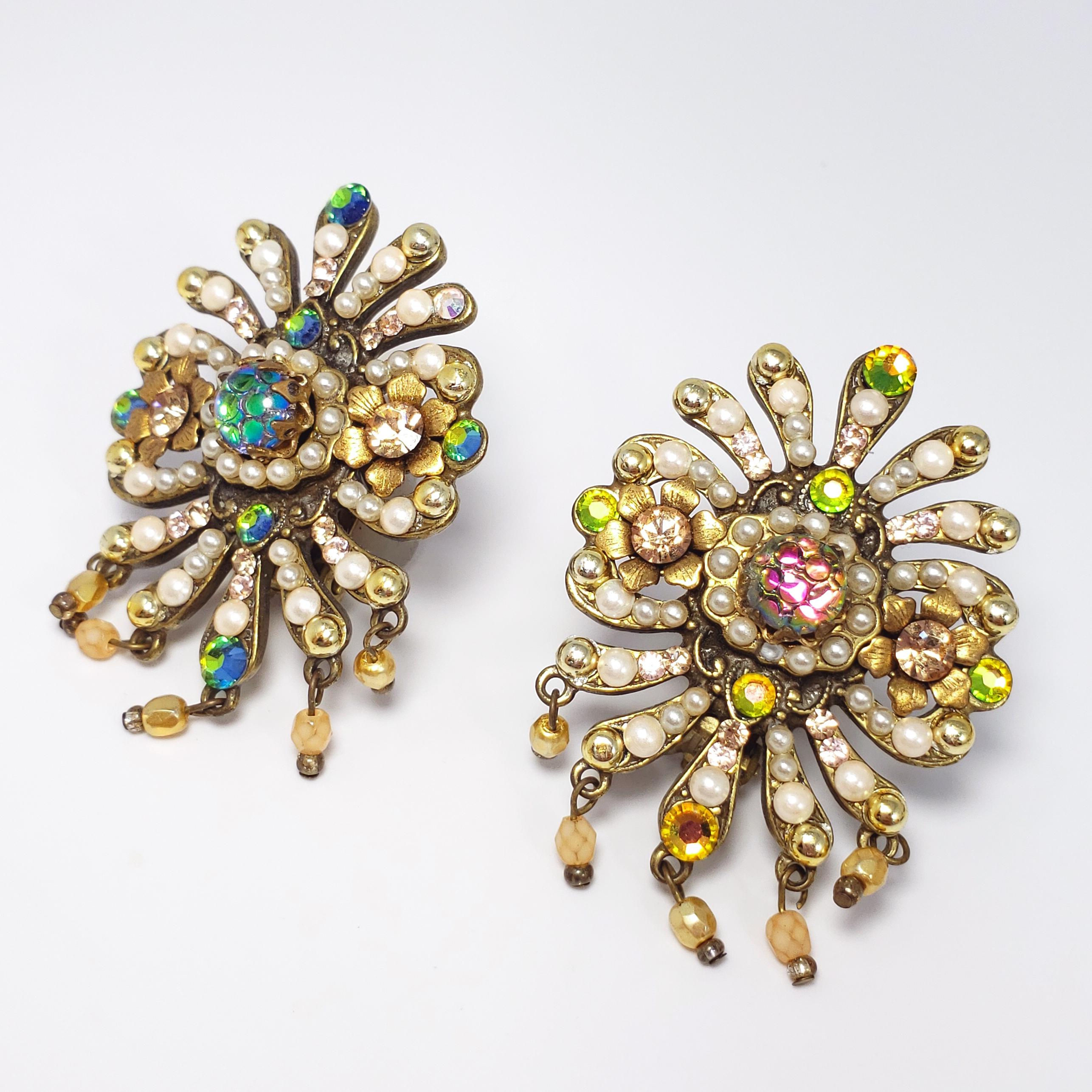 A pair of fabulous and bright floral-themed earrings by Michal Negrin. A vintage design from the 1980s-1990s, when Michal Negrin first began making jewelry. Features floral motifs, accented with faux pearls, champagne colored chaton crystals, and