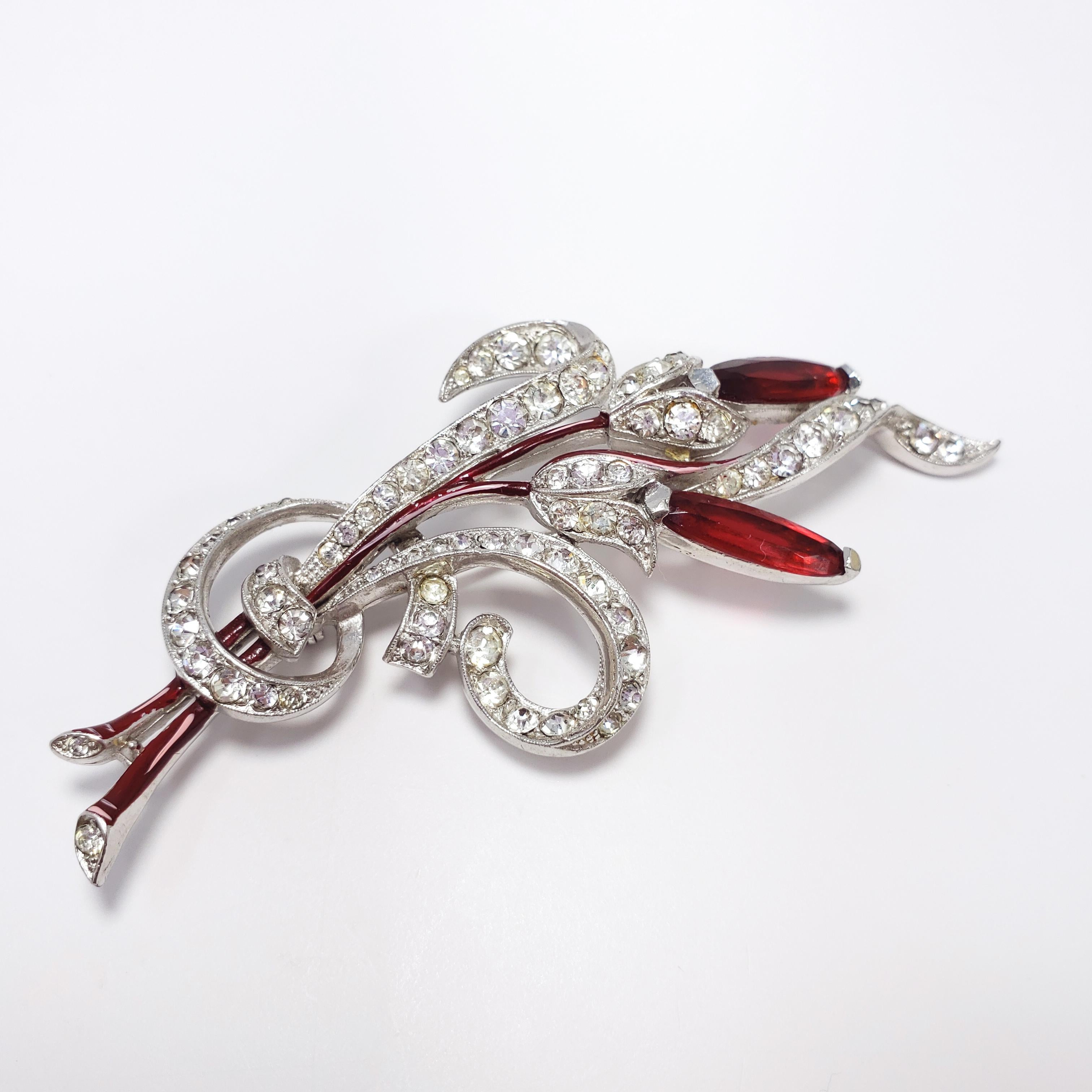A vintage brooch from Trifari, designed by Alfred Philippe during the mid 1950s. Features rhodium plated setting, with prong set ruby-red navette crystals and bezel set clear chatons. Accented with red and pink enamel. An excellent addition for your