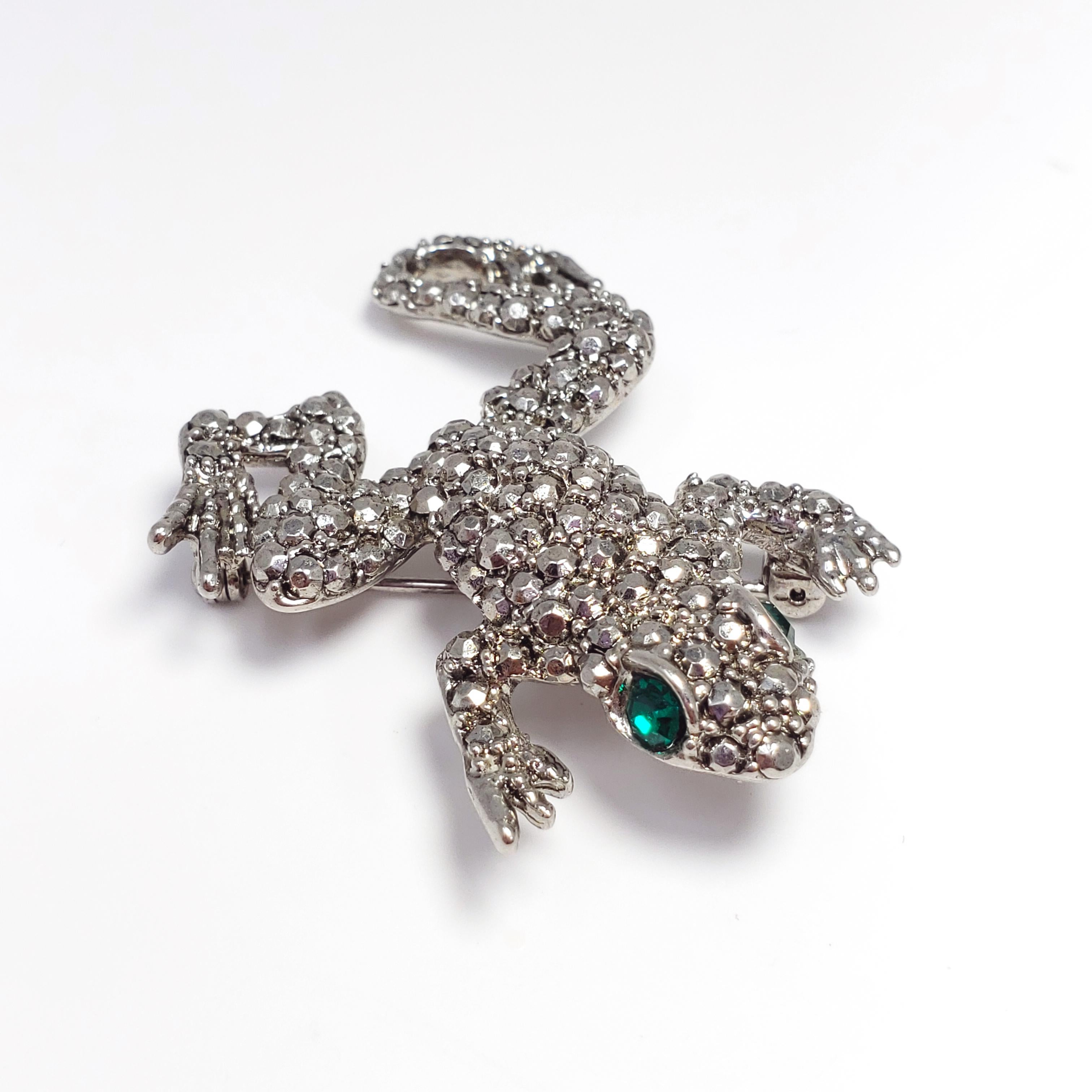 Silver frog brooch with pave marcasite and two brilliant green eyes. A whimsical vintage accessory from Hobe, circa 1940s.

Hallmarks: Hobé ©