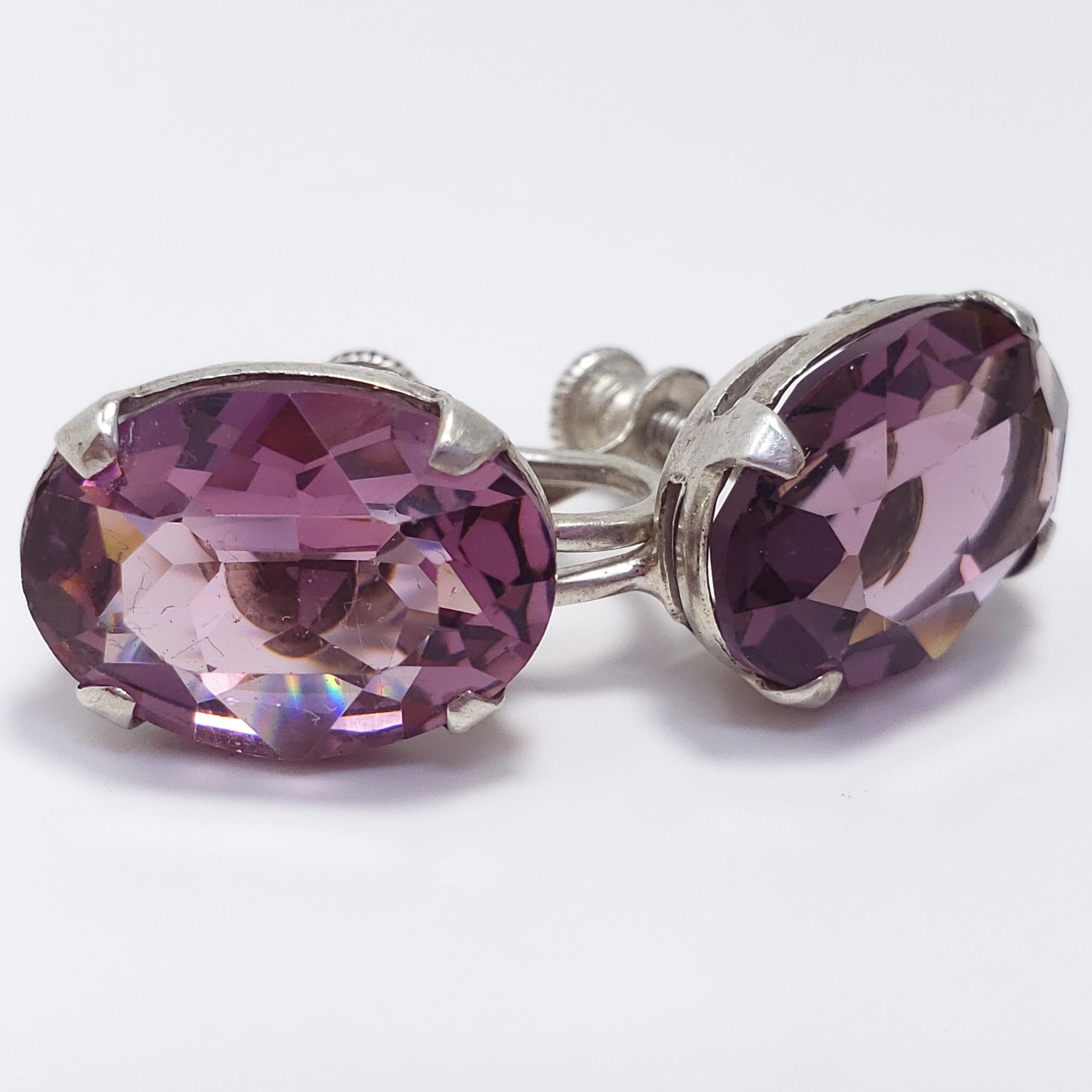 A pair of Victorian earrings, circa early 1900s. Each with an elegant amethyst, prong set in open-back sterling silver. Features screw-back hardware, which was widely incorporated into jewelry designs during the era.

1.4 x 1.0 cm
5 g
Hallmarks: