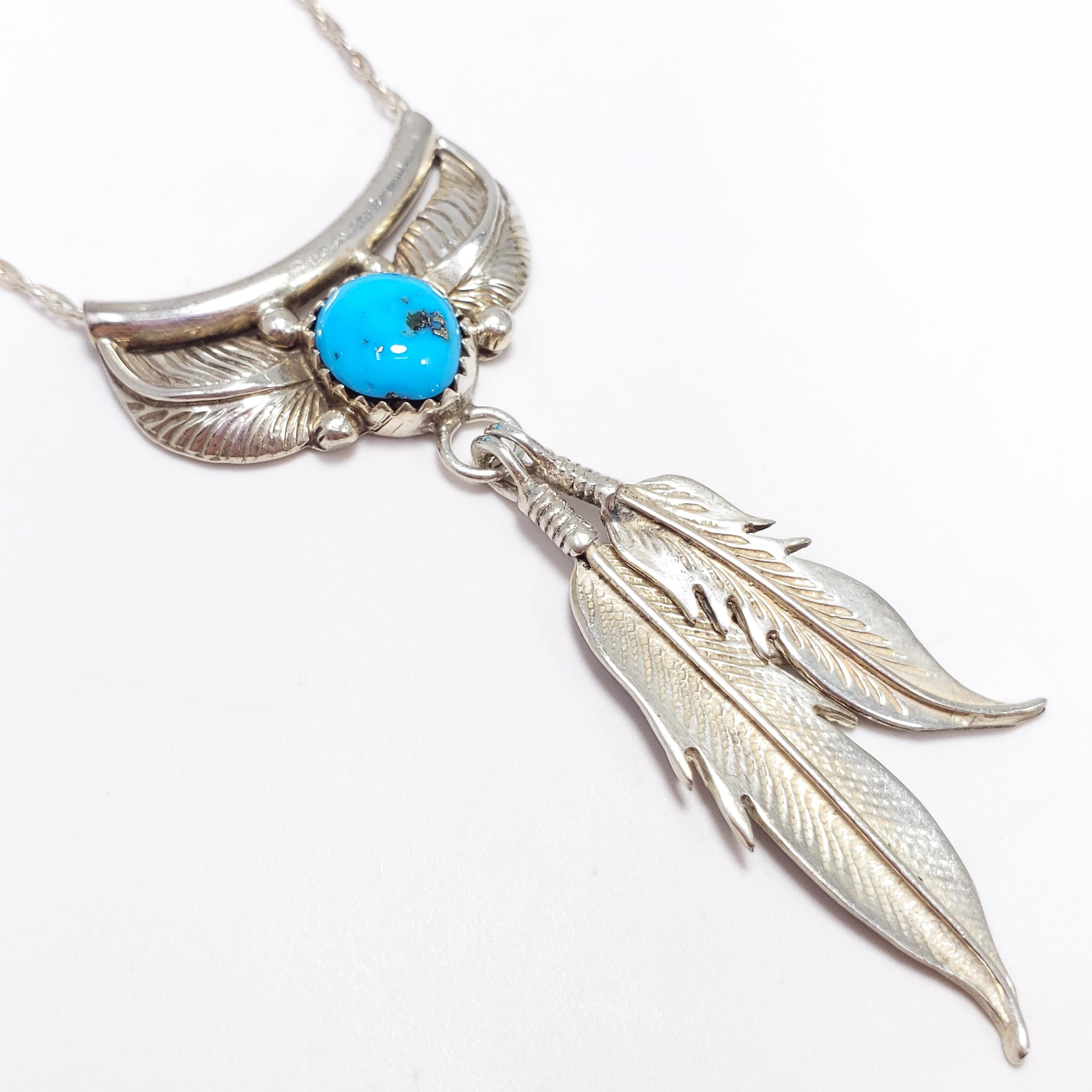A minimalist Native American Navajo pendant necklace. Features a floral/feather themed pendant motif with a bezel-set natural turquoise stone, accented with two dangling feathers - all sterling silver, including the fine chain.

Hallmarks: Necklace