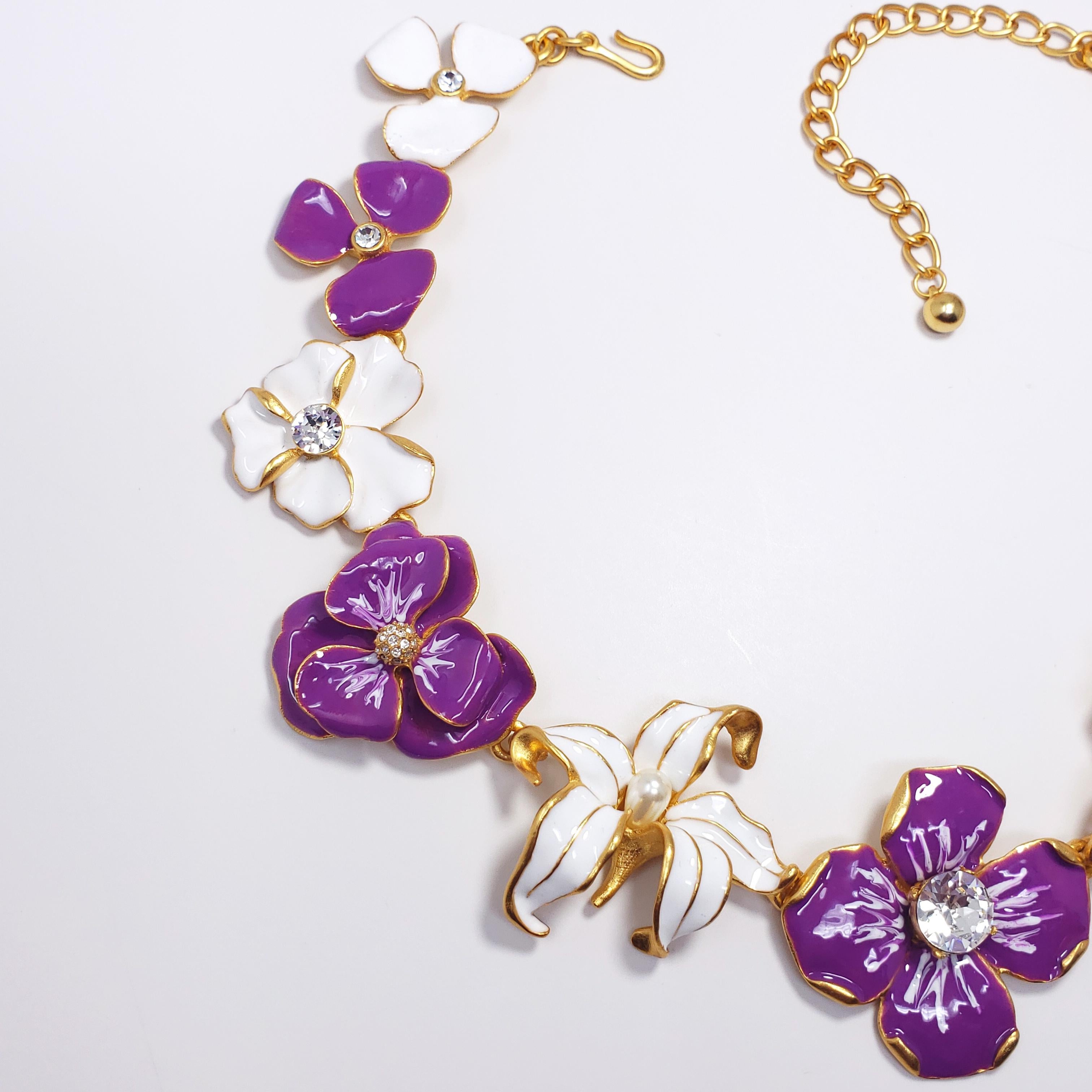 This textured 22K gold-plated metal features an assortment of linked white and purple enameled flowers, accented with crystals and faux pearls. By Kenneth Jay Lane, made in USA.

Weight: 119 g
Hallmarks: Kenneth © Lane
Flower sizes from 2.6 to 4.1