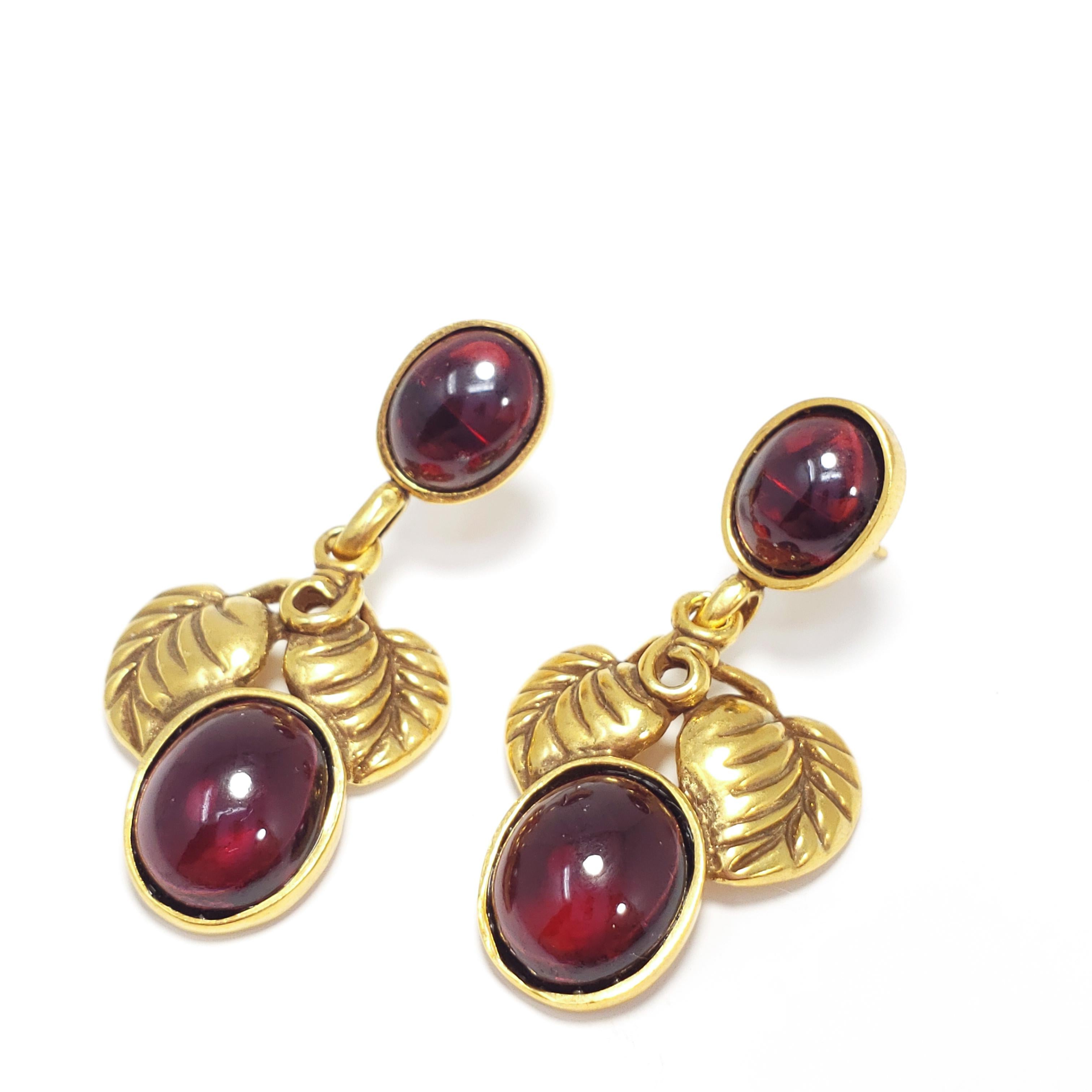 A pair of vermeil (sterling silver, gold plated) earrings, accented with open back garnet cabochons and floral leaf motifs. Post backs, circa mid 1900s.

Hallmarks: Sterling, MFA
