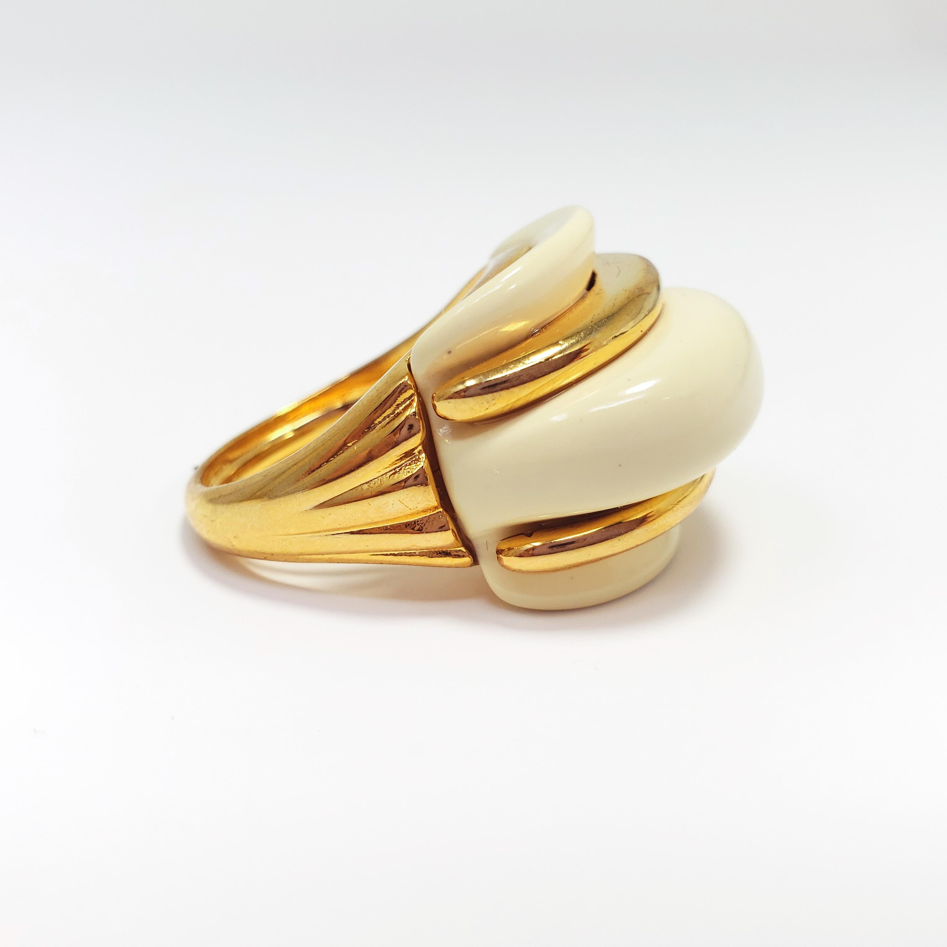 A stylish statement ring by Kenneth Jay Lane. This cocktail ring features cream resin accented with gold-plated metal for a bold yet sophisticated look.

Ring face height: 2.1 cm
Adjustable ring size, fits US 4-8
Hallmarks: © KJL, Made in USA