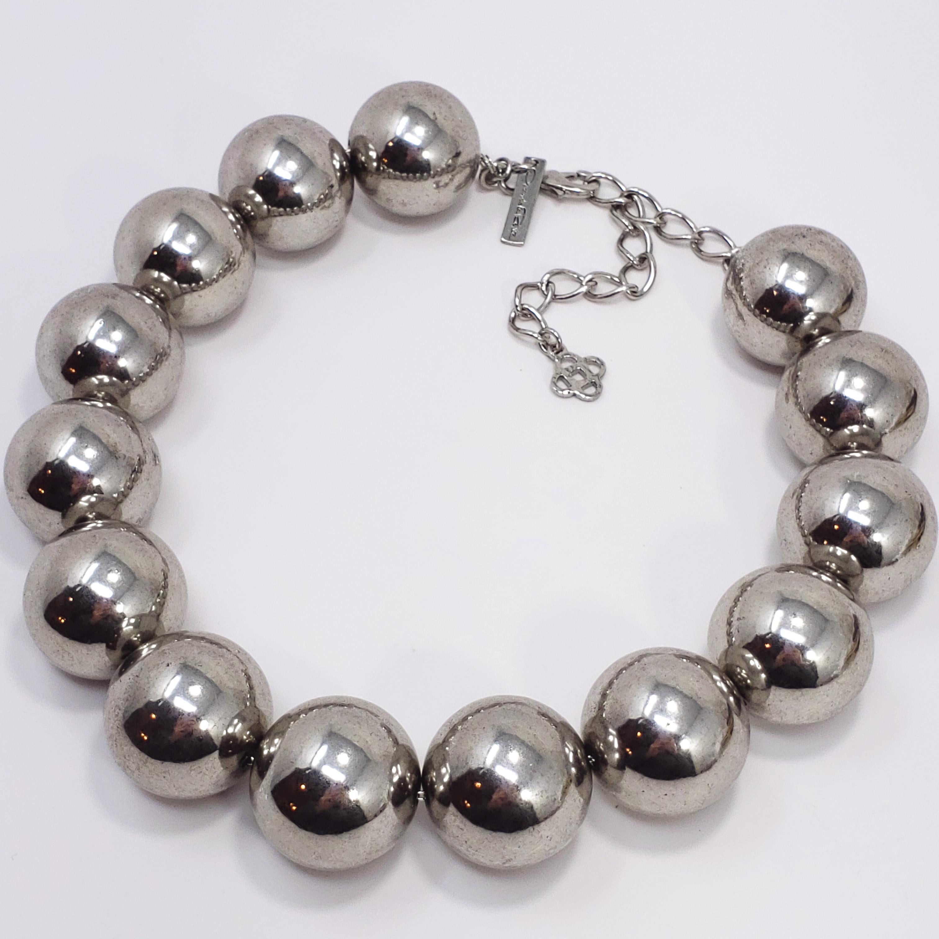 A bold oversized bead necklace by Oscar de la Renta. This necklace features large beads in a reflective, metallic, tarnished finish on a fine chain.  Large and loud, this necklace is sure to make a statement! Excellent unworn vintage