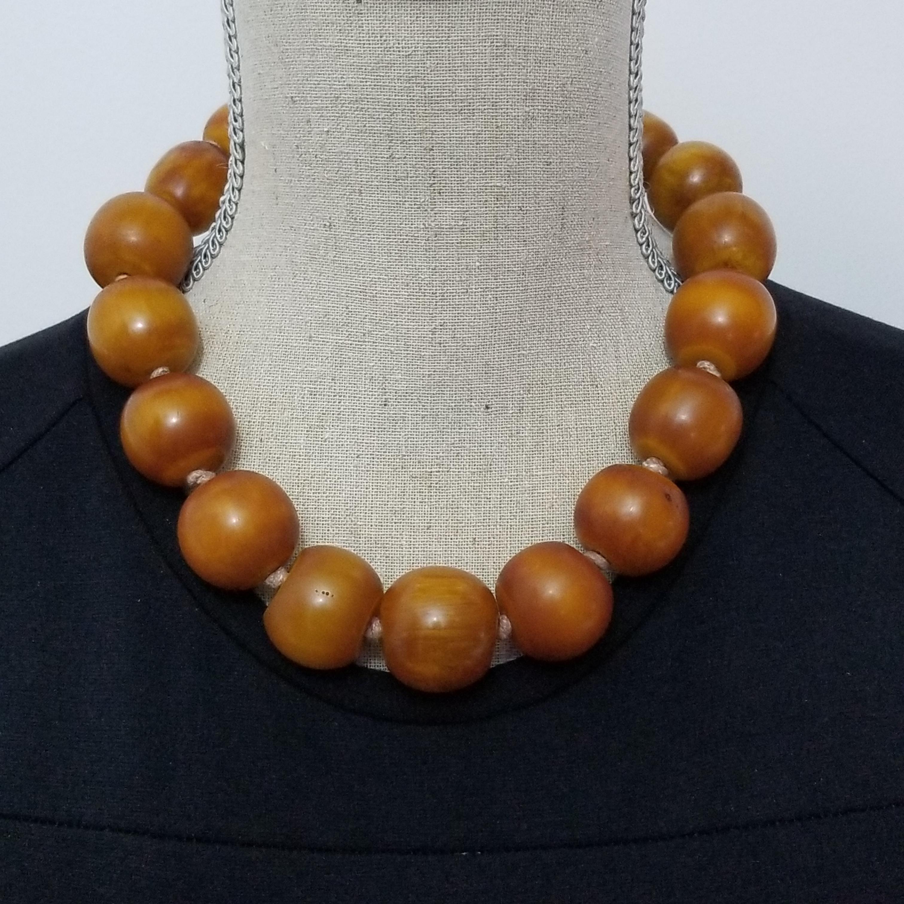 Bold & bright! This vintage bakelite necklace features large, chunky, graduated butterscotch bakelite beads on a sturdy vintage knotted string. A large 14K gold spring ring clasp is as eye catching as the beads themselves. Excellent condition and