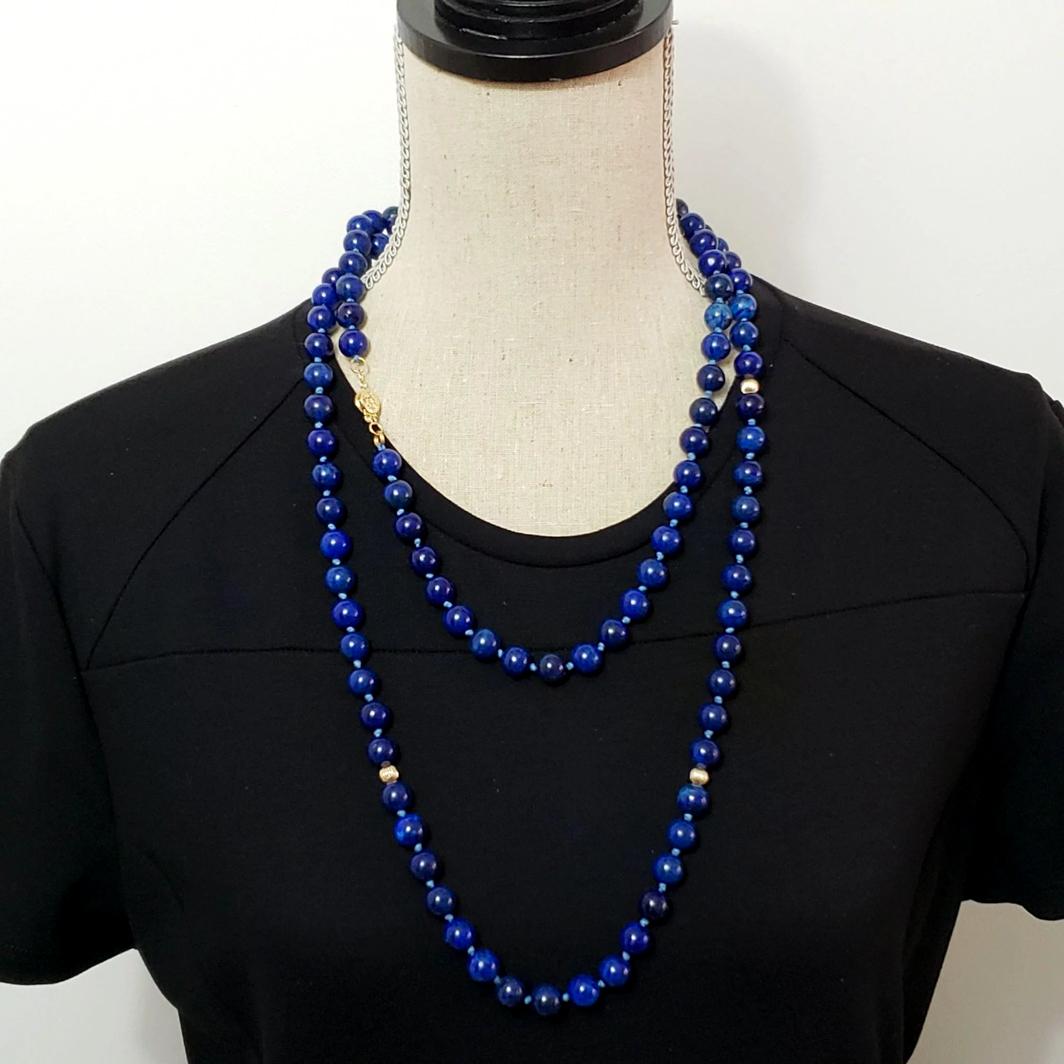 Vintage AAA grade, natural blue Lapis Lazuli on a matching knotted string with 14kt gold beads and 14K gold clasp with safety latch. The gorgeous stones are flecked with glowing golden flakes. Every part of this necklace, from the string to the
