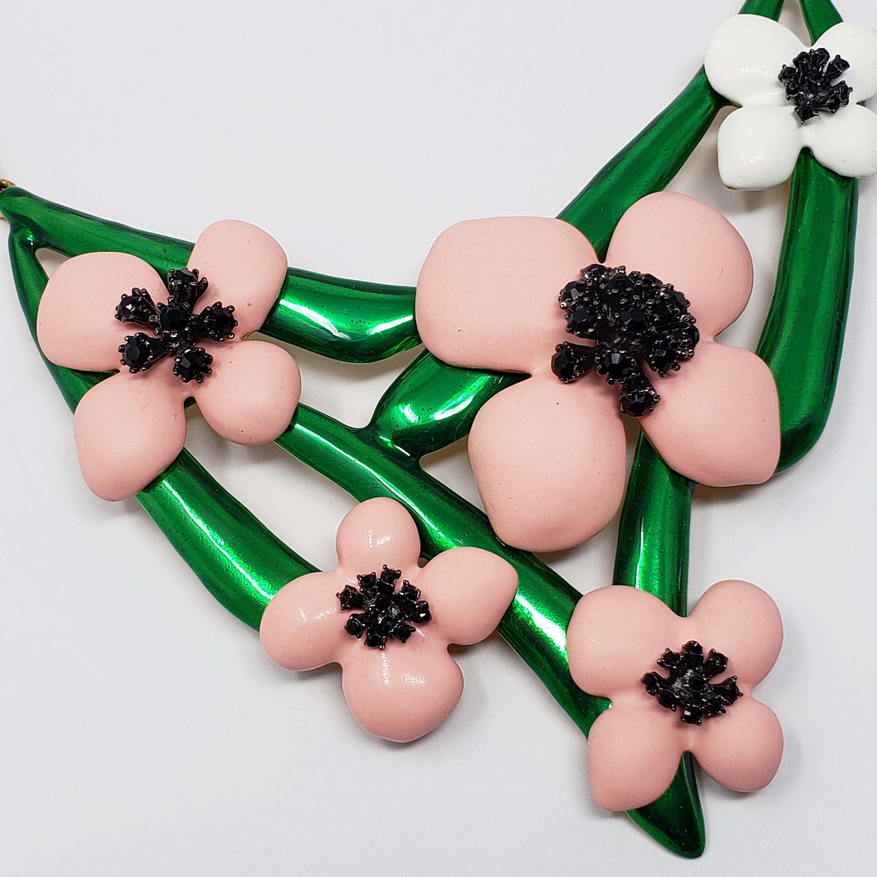 A blooming bouquet! A charming necklace from a rare Oscar de la Renta floral collection. The flowers feature soft pink and white resin petals on a painted green, gold plated setting. The jet black crystals add striking contrast to these bright and