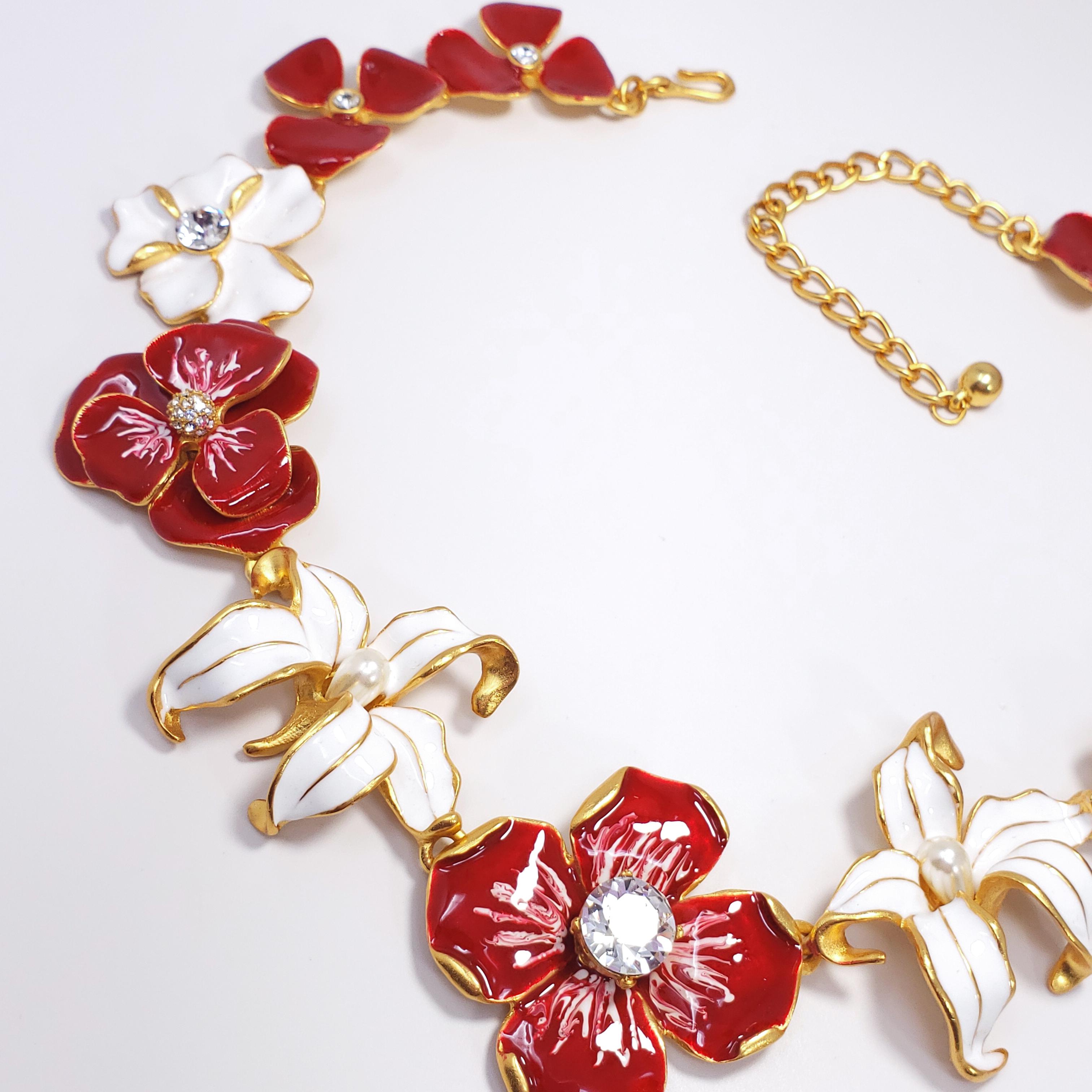 This textured 22K gold-plated metal features an assortment of linked white and red enameled flowers, accented with crystals and faux pearls. By Kenneth Jay Lane, made in USA.

Weight: 119 g
Hallmarks: Kenneth © Lane
Flower sizes from 2.6 to 4.1