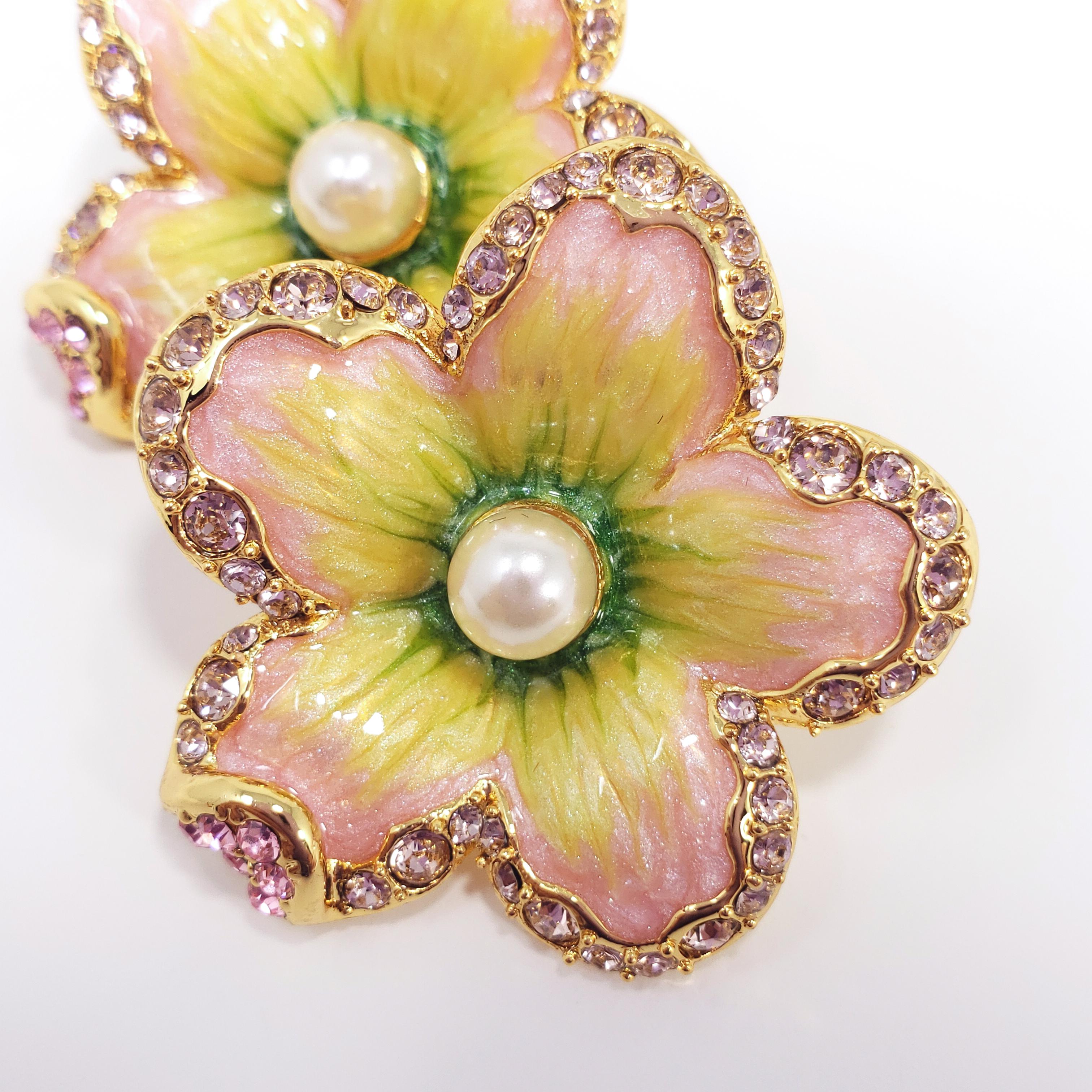 Flower power! A pair of ornate floral clip on earrings featuring pink crystals & faux pearls. Painted with green and pink enamel. Set on gold plated metal.

Hallmarks: Jay, Jay Strongwater, CN

By Jay Strongwater, originally for HSN.