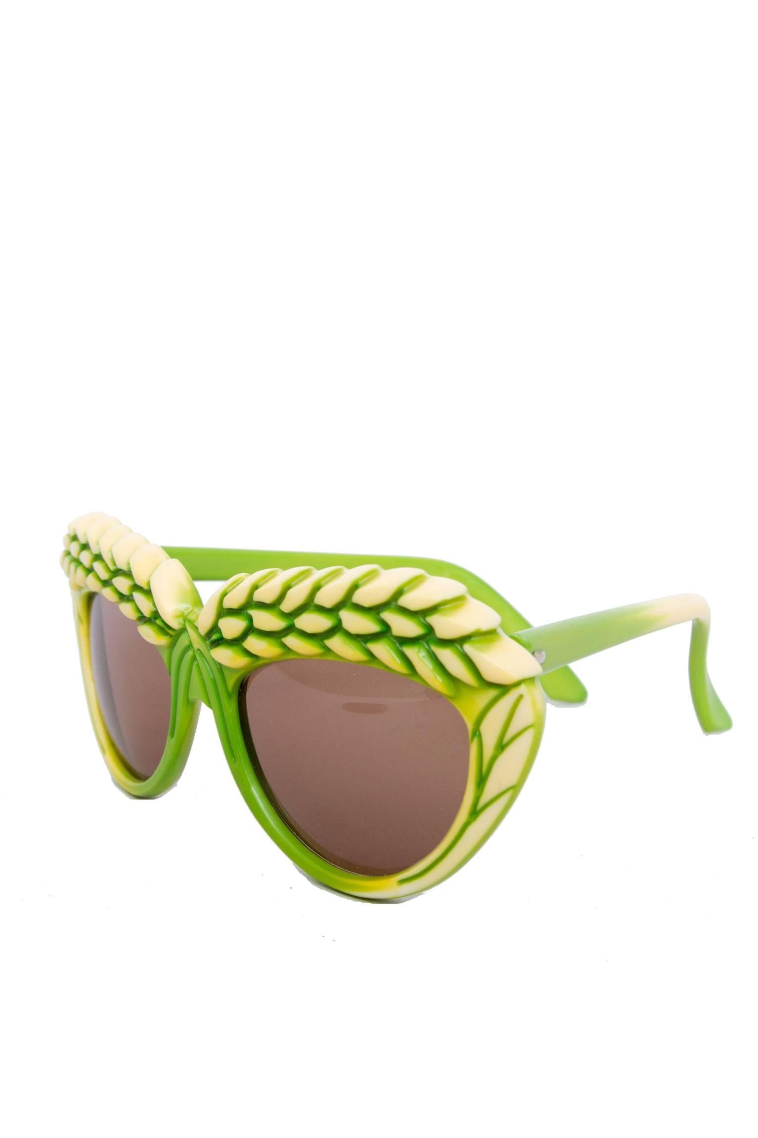 A rare, bright pair of 1980s green Isabel Canovas sunglasses with brown tinted lenses  and a detailed frame, where two yellow barley heads stretch across each lens. 

