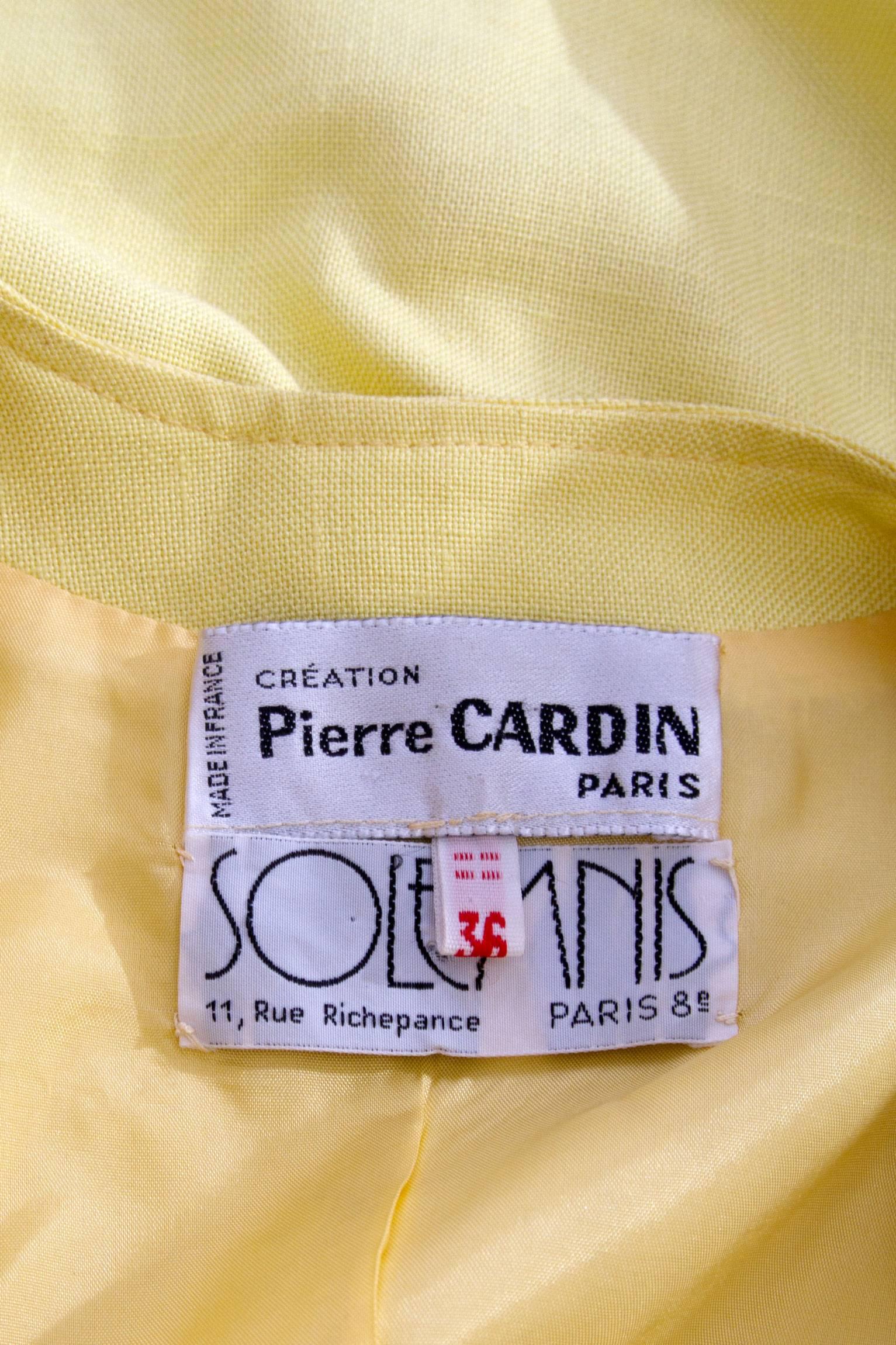 A lovely 1980s Pierre Cardin canary yellow linen skirt sut consisting of a fitted jacket and fitted pencil skirt. The jacket has a front buttoned push button closure, a nipped in waist and exaggerated shoulders. The pencil skirt has a back zipper