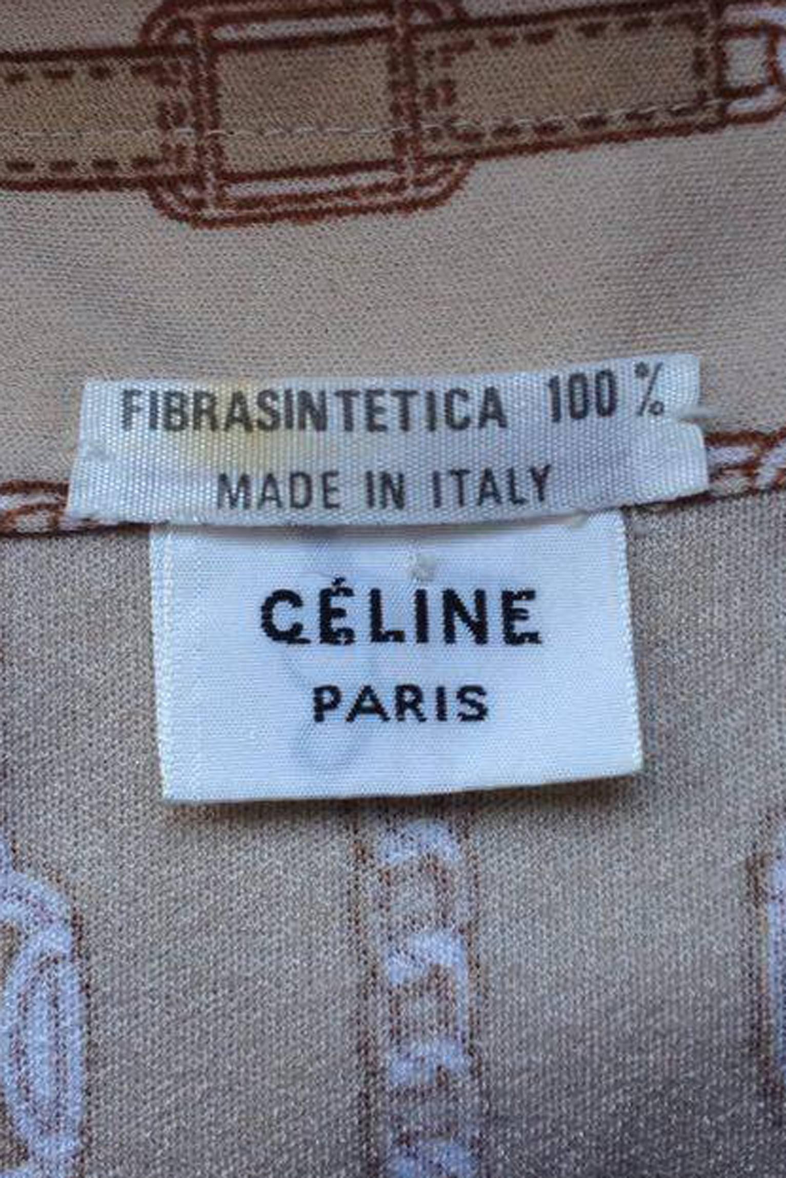 A 1970s beige Celine blouse with long tapered sleeves with two buttoned cuffs and a front buttoned closure. The gorgeous blouse features the iconic chain print with ‘Celine’ logo inserts which elongates the length by its vertical placement. 

The