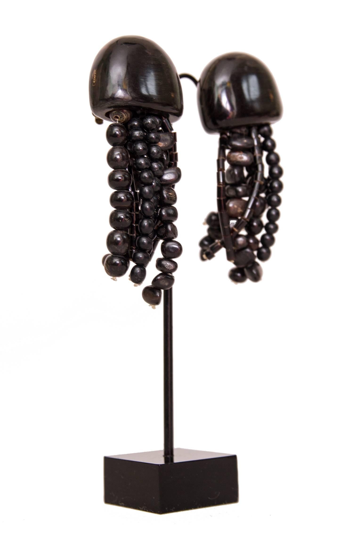 A pair of 1980s bone and wood Monies dangle clip-on earrings with multi-stranded wooden beads of varying shapes and sizes.
