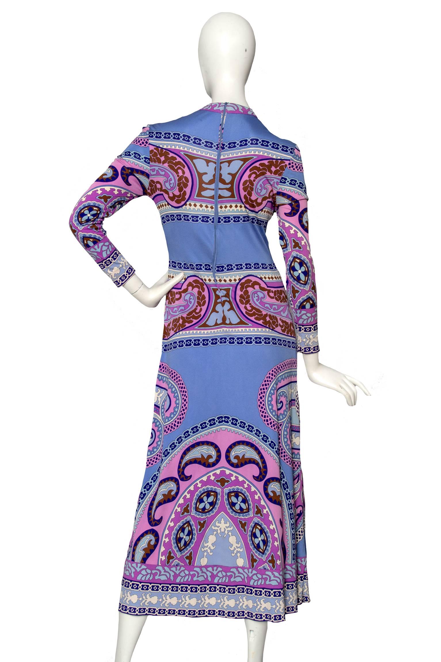 A stunning 1970s unlabelled Leonard silk jersey midi dress with a pink, blue and brown paisley-inspired print. It has long tapered sleeves and a back zipper closure. 

The size of the dress corresponds to a modern size Small. 