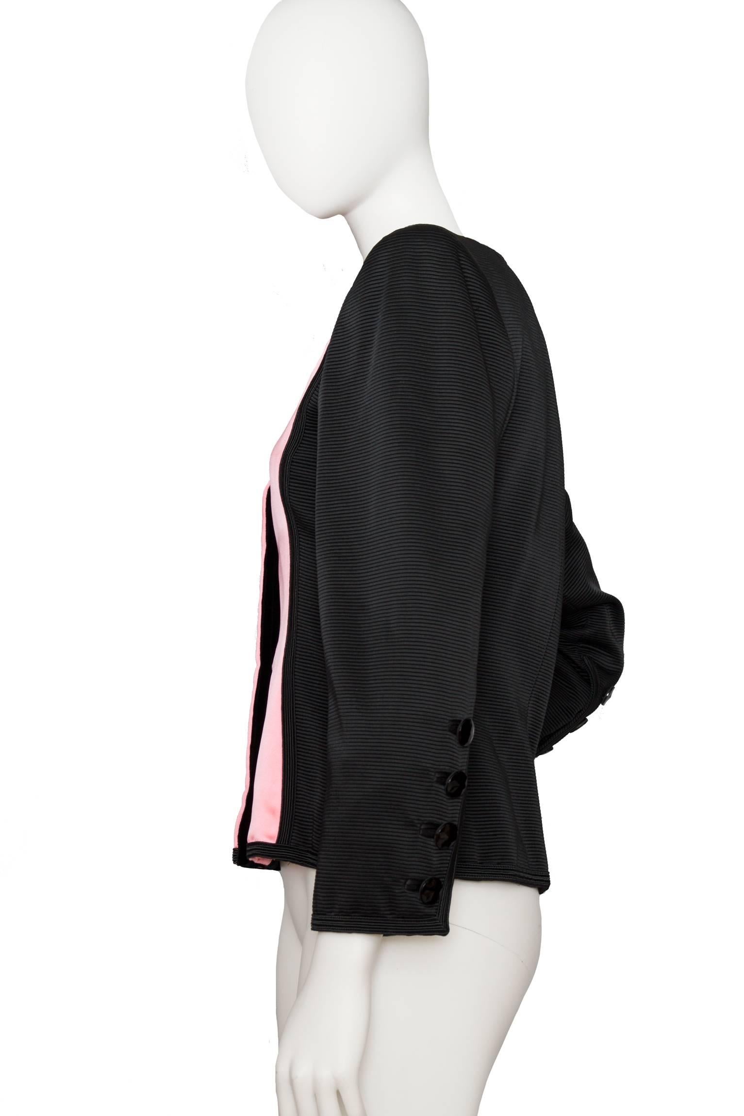 An incredible iconic vintage Yves Saint Laurent Rive Gauche pink and black blazer with long tapered sleeves with four faceted buttons at the cuff. The blazer consists of a solid light pink panel at the front providing a delicate contrast to the