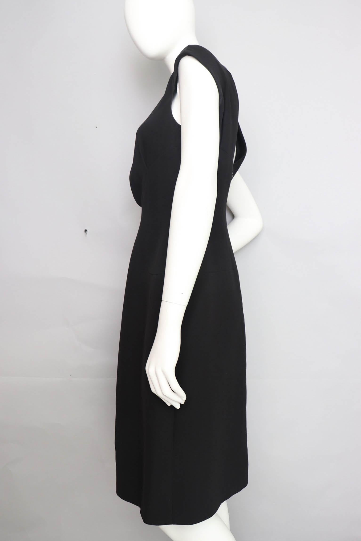 A great 1990s Chanel little black silk dress with cap sleeves and ruching in the center front. The gorgeous simple dress has a fitted waist and paneling that beautifully mirrors the curves of the hip. The dress is fully lined in black silk and has a