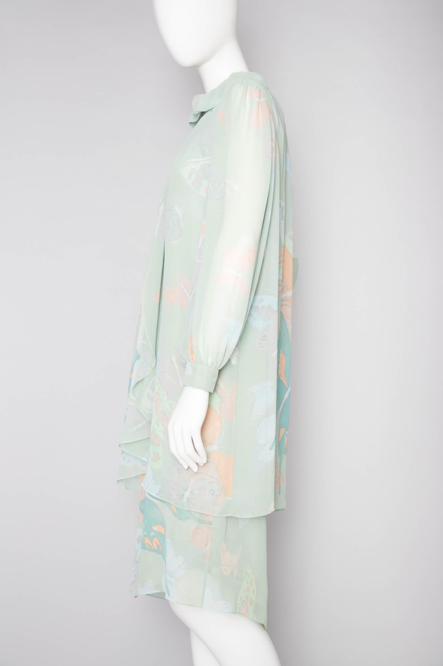 A 1970s Hanae Mori two-piece ensemble consisting of a classic shift dress and delicate overcoat. The sleeveless dress as a sweetheart neckline and back zipper and hook & eye closure. The sheer overcoat has a ruffle collar and a flowy waterfall