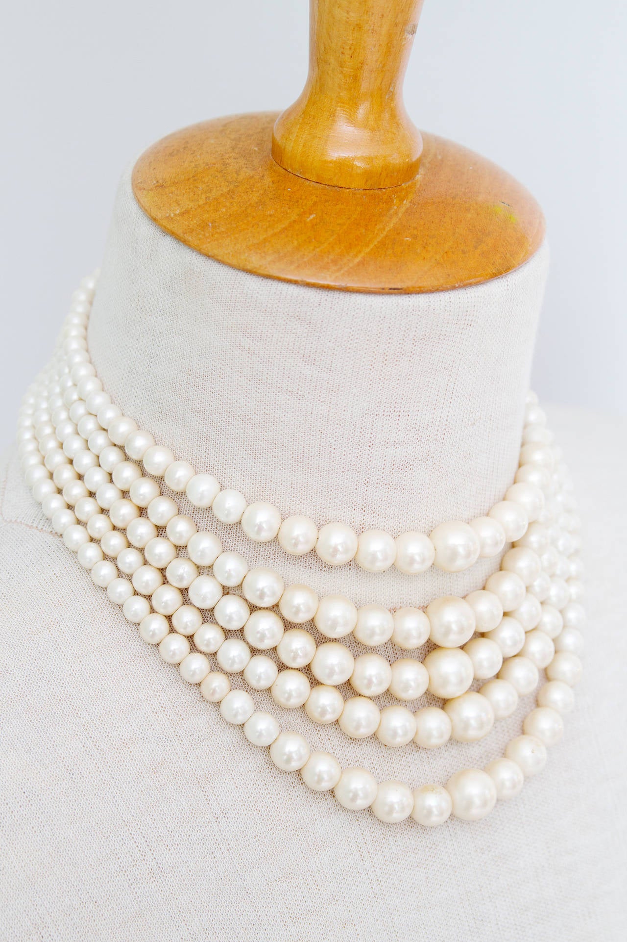 A 1960s Christian Dior five strand pearl chocker with silver hardware. The size of the pearls range from 0.5 cm to 1.2 cm in diameter.

The necklace is stamped: Christian Dior 1961.