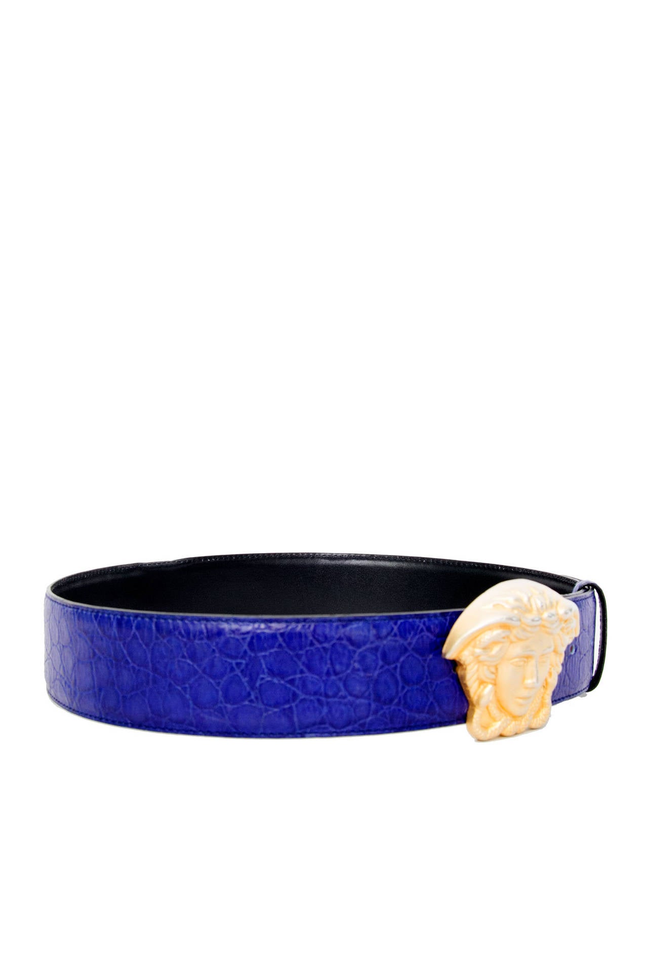 A late 1980s Gianni Versace royal blue leather belt with an exaggerated gold Medusa buckle.