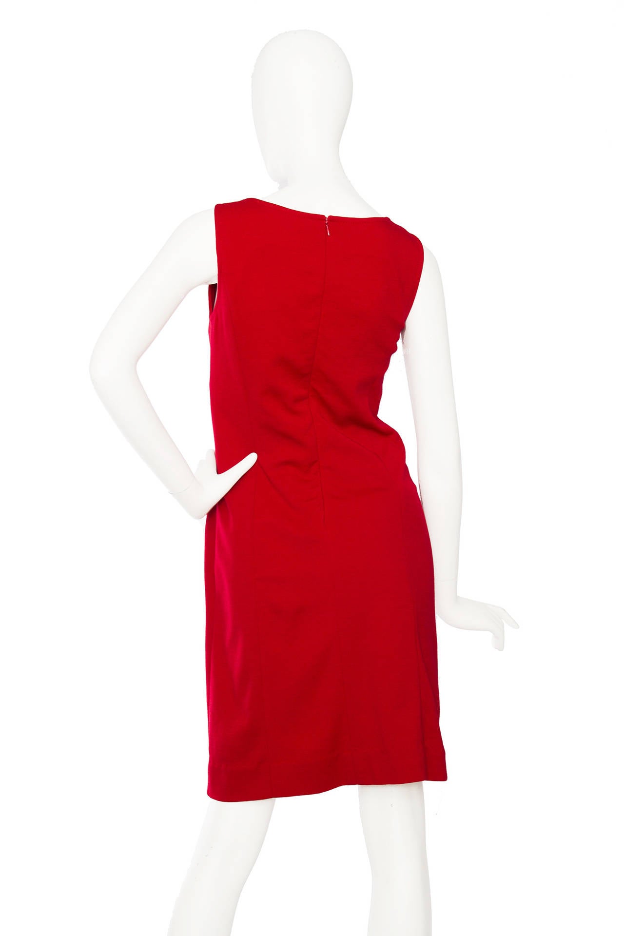 A 1960s Pierre Carding red space age mini dress with a back zipper closure. The dress has a round neckline and black dots down the front in a contrasting fabric and varying in size. 

The size of the dress corresponds to that of a modern size
