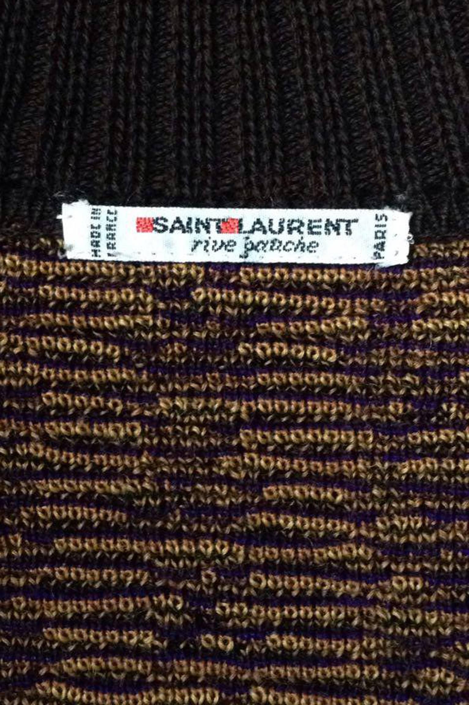 A colorful 1980s Yves Saint Laurent double breasted wool cardigan with a large abstract print in demure brown, purple and yellow colors. The double breasted closure is completed by eight sculptural gold buttons. 

The size of the cardigan