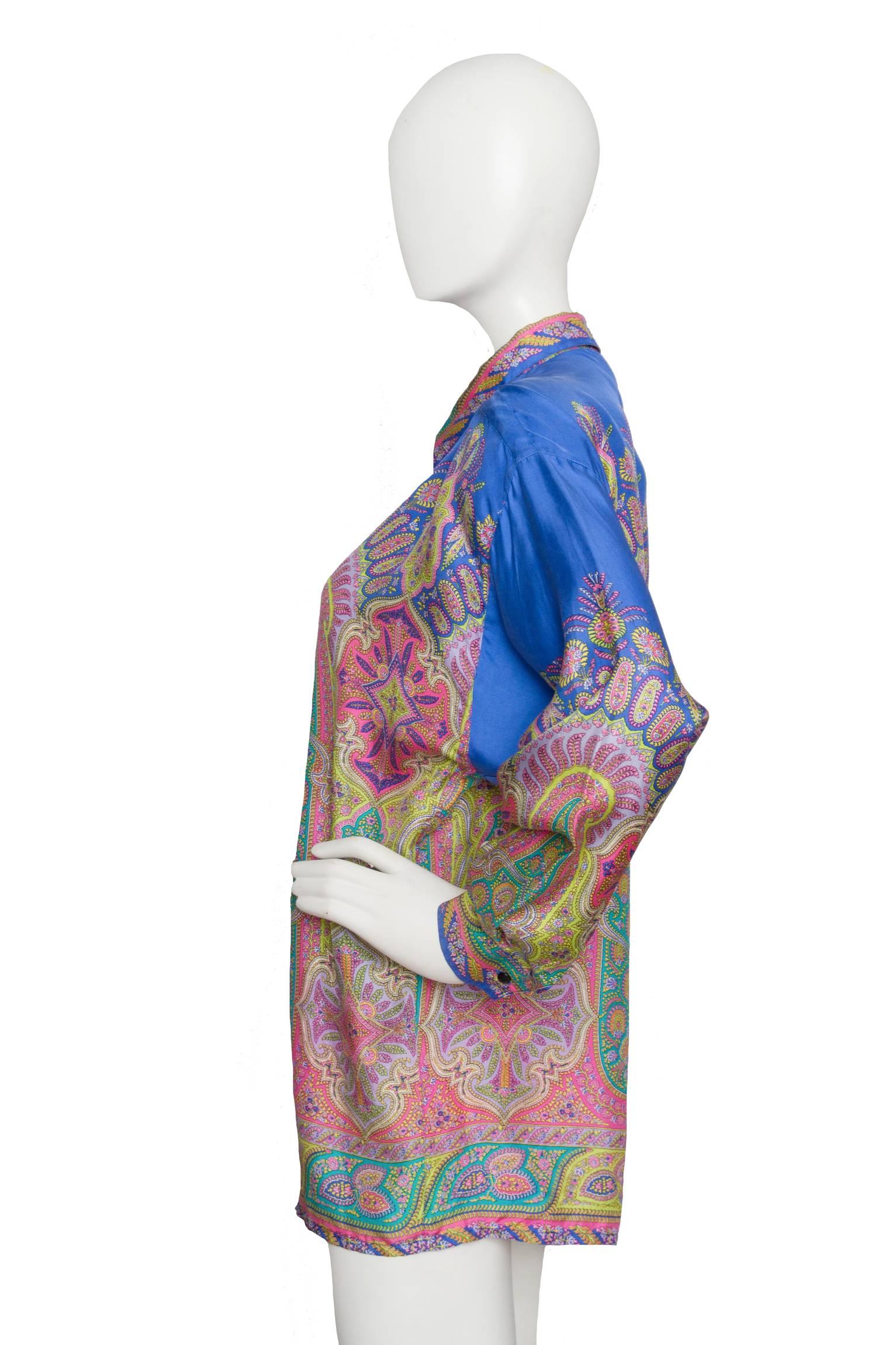 A gorgeous 90s Versace paisley print silk shirt with a hidden front buttoned closure and one button cuffs. The intricate paisley print is held in bright pink, green and yellow set on a light blue background. 

The size of the blouse corresponds to