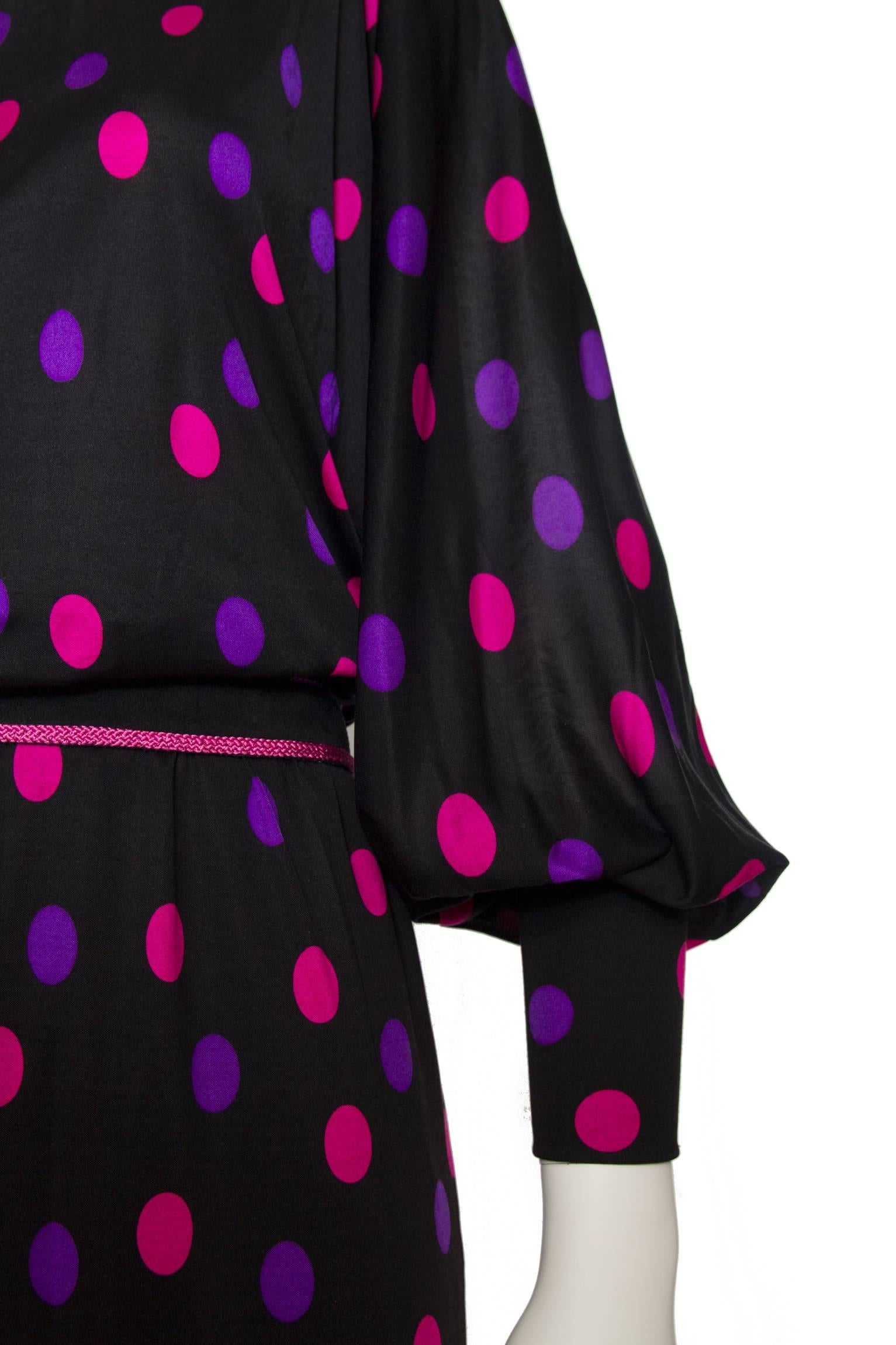 A great 1970s Lanvin black full-length skirt with long sleeves, a round neckline and a pink and purple polka dot print. The voluminous sleeves are fastened at the cuff with multiple buttons. The dress closes in the back with a zipper and hook &