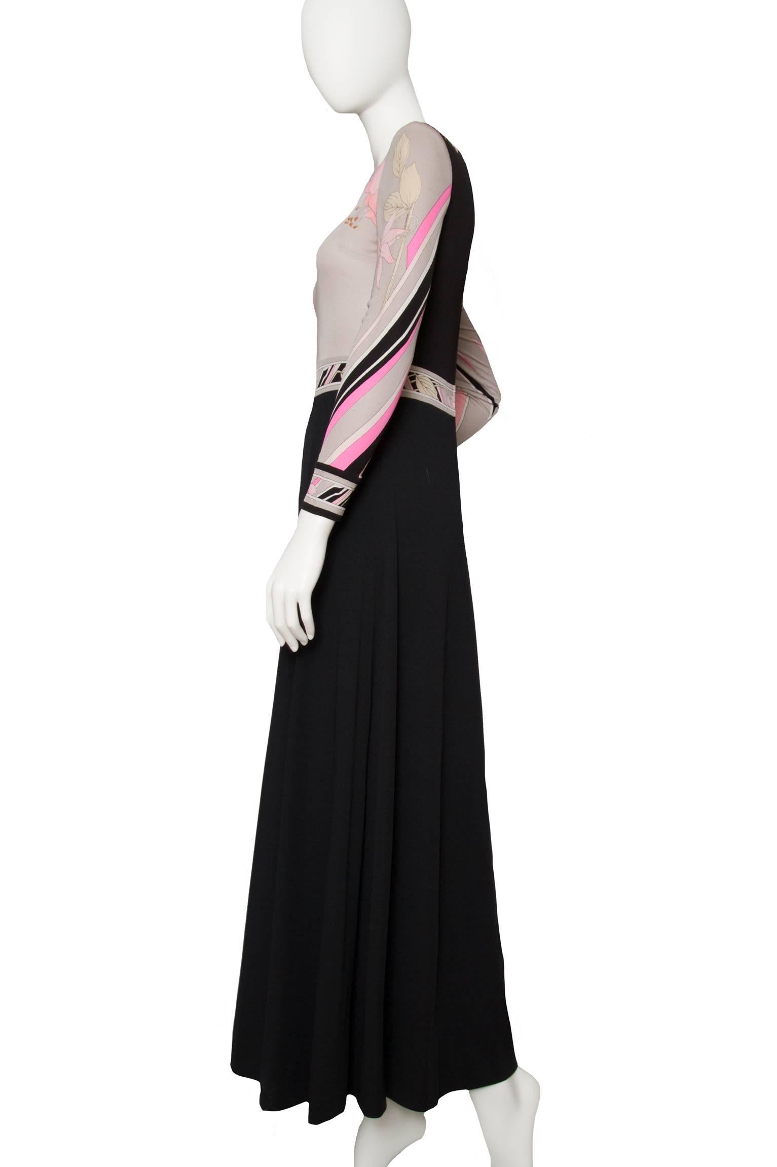 A lucious 1970s silk jersey dress consisting of a fitted bodice and and full length skirt. The fitted bodice is clad in the characteristic floral Leonard print and is held in a subtle color scheme of pink and white with grey and black accents. The