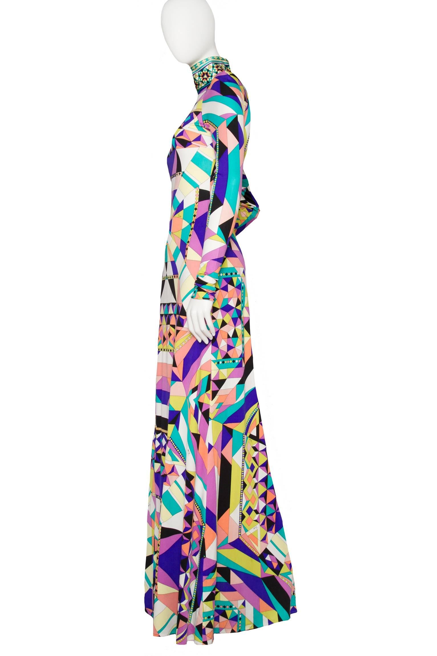 An absolutely incredible Emilio Pucci luscious silk jersey maxi dress with extra long tapered sleeves and a high collar that is fastened at the back with multiple Pucci engraved plastic buttons. The amazing abstract print is held in bright colors