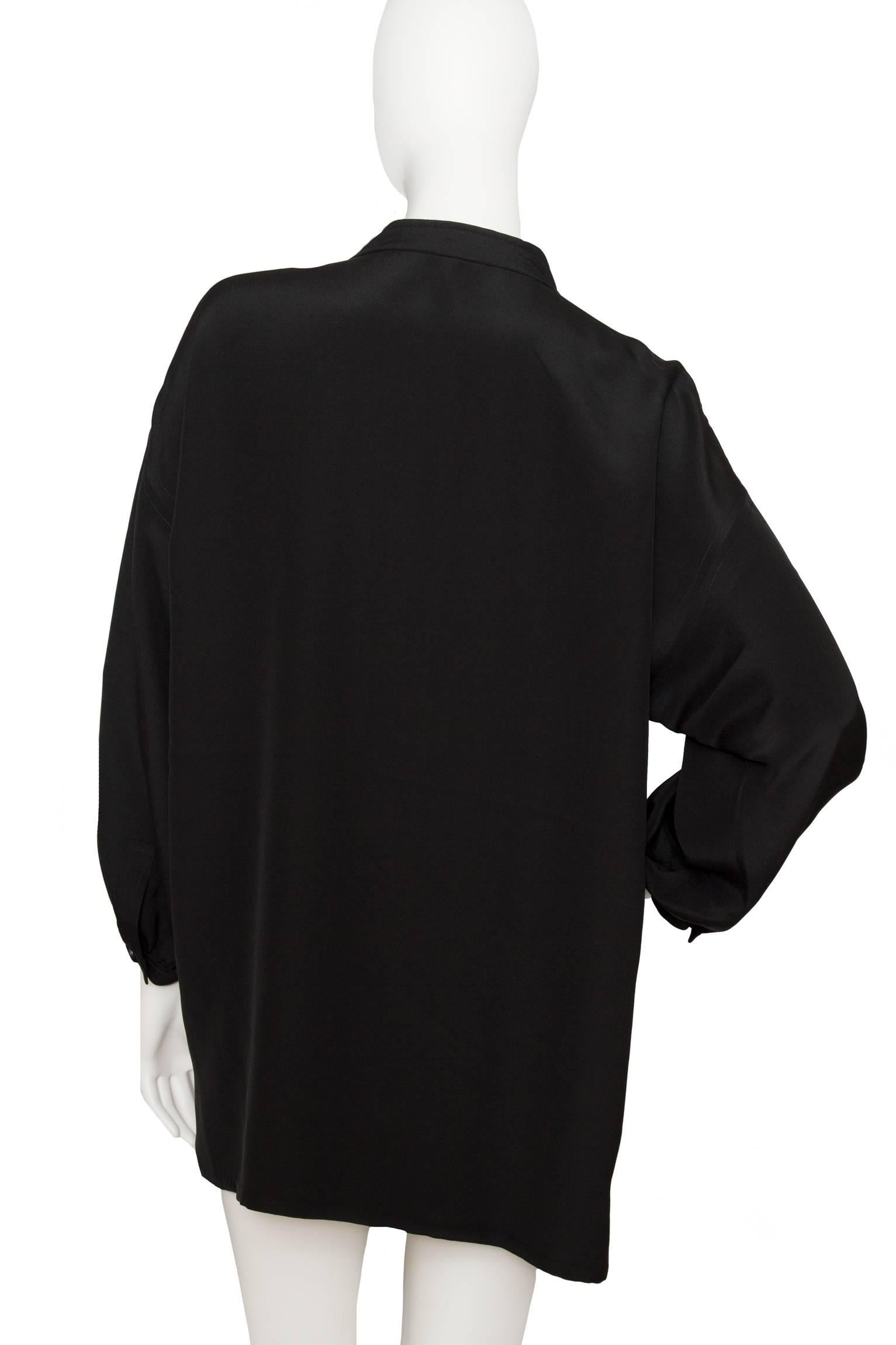 A classic and versatile 1980s black Givenchy blouse with long sleeves with one button cuffs and a two-button closure at the collar. Couture numbered behind Givenchy label

The size of the blouse corresponds to a modern size Large. 