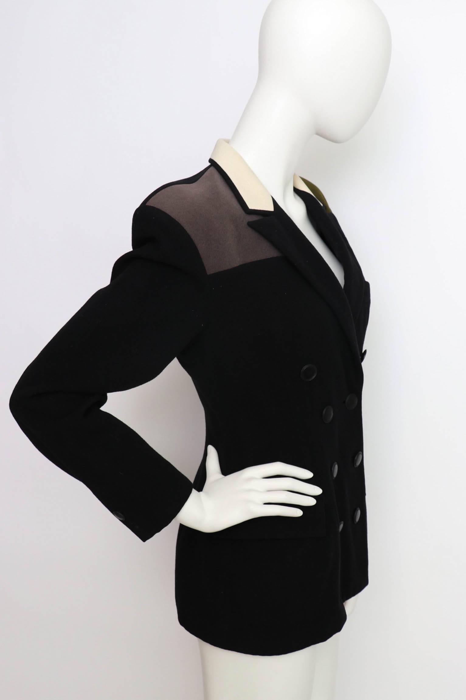 A gorgeous double-breasted 1980s Yohji Yamamoto black fitted wool blazer with long sleeves, a fitted waist and contrasting panels at the shoulder and collar. Both a dark forest green and charcoal colored panel are situated on each shoulder whilst an