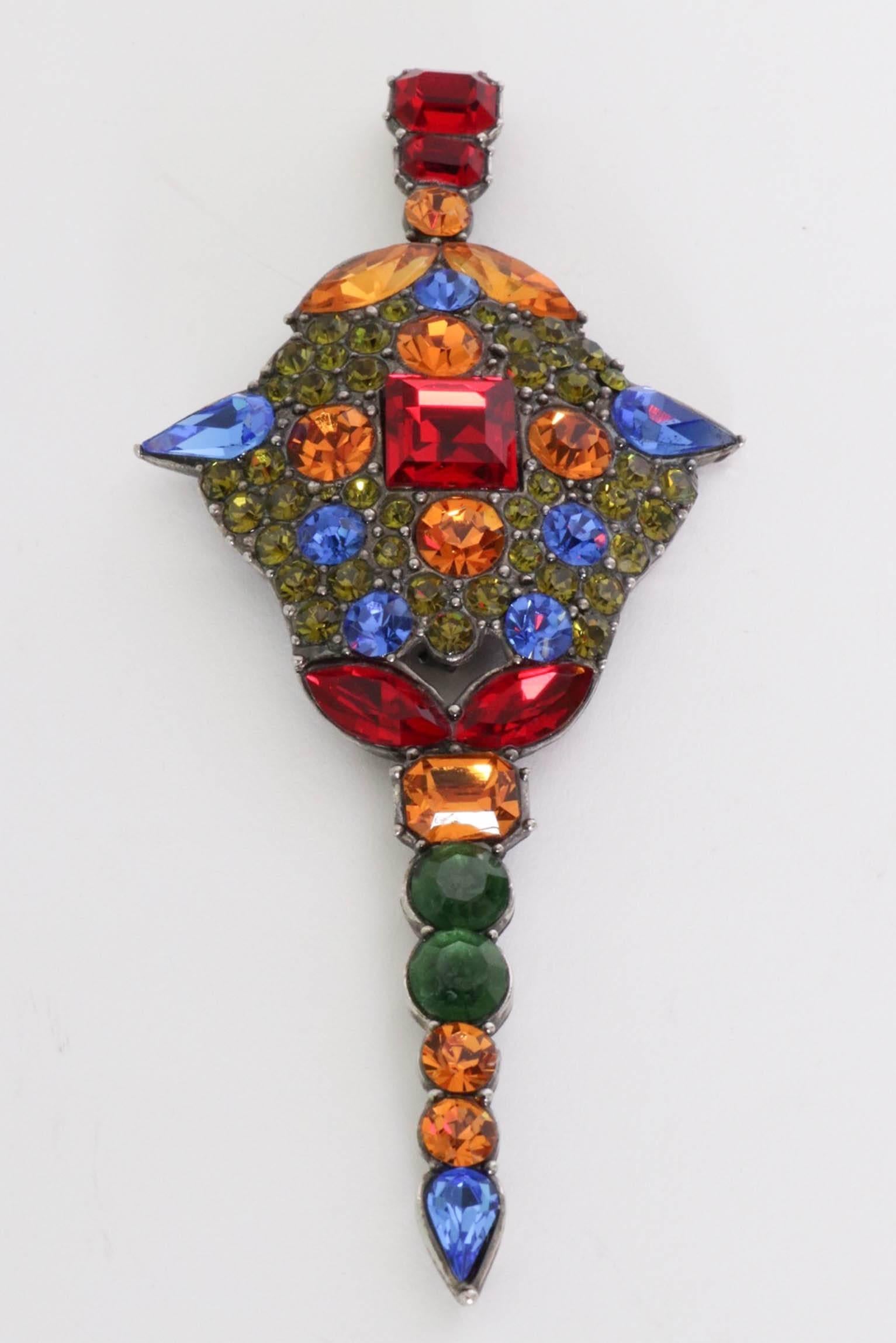 An absolutely stunning 1970s Yves Saint Laurent multi-colured rhinestone studded brooch. The stone settings are held in bold primary colours set on a base of minor sparkling green studs as well as vary in size and shape. 

Stamped:  