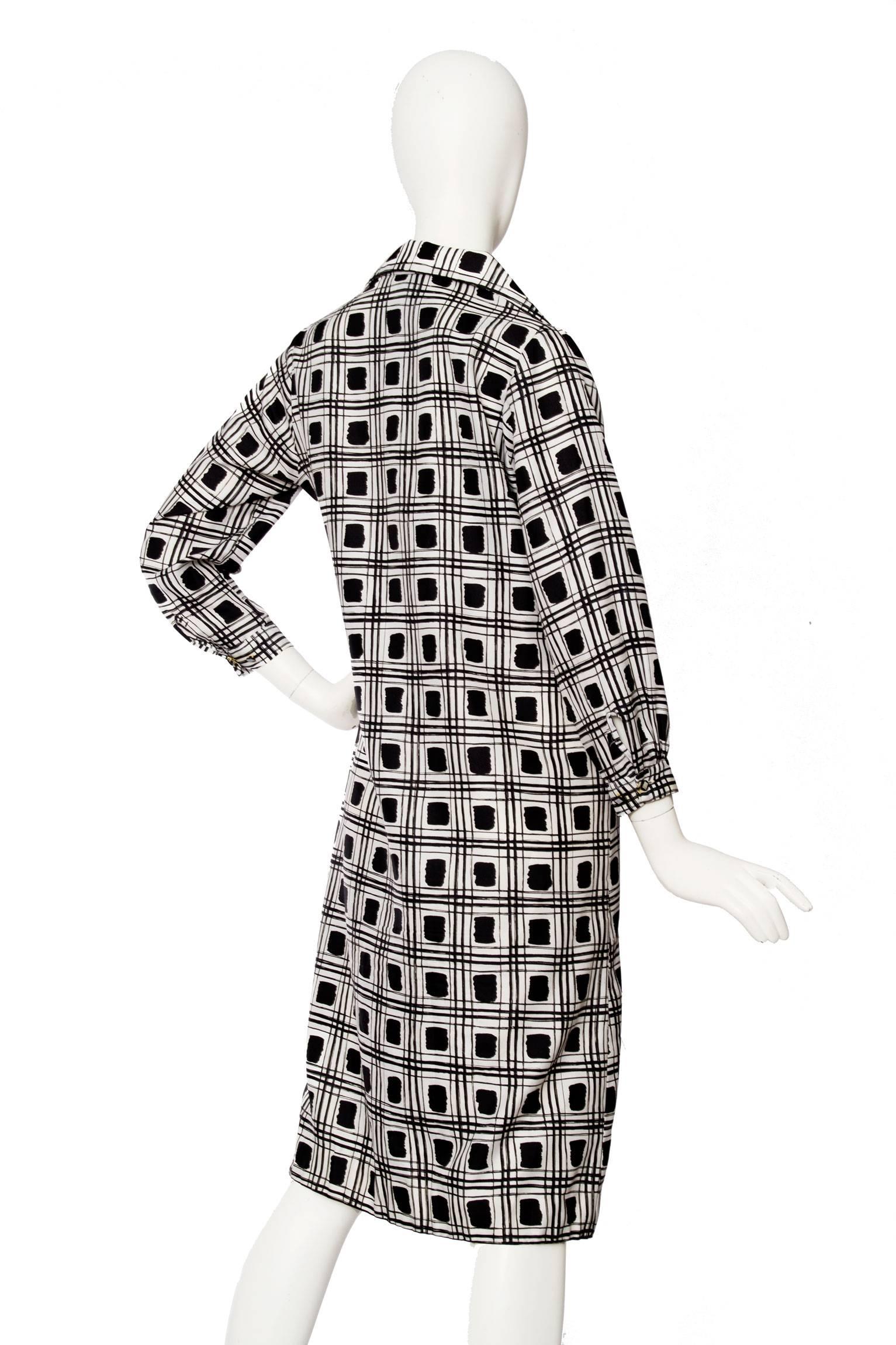 A lovely 1970s Lanvin tunic dress with a black and white graphic print and a characteristic 70s collar with pointed edges. The tunic is held in an overall monochrome colour scheme and is made in polyester. Down the front the tunic has a contrasting