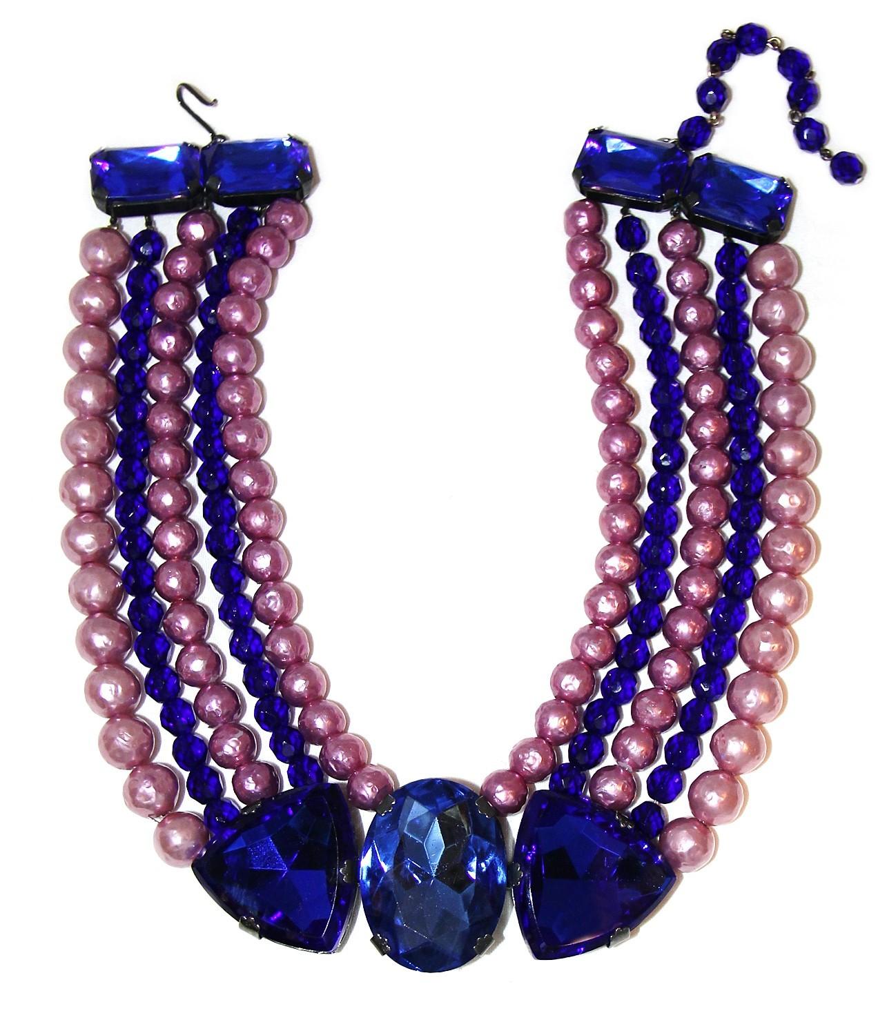 Circa 1970s Yves Saint Laurent Rive Gauche multi-strand necklace with faceted cobalt blue beads and textured faux-pearls in pink and mauve, with a center piece of a large prong set faceted glass in two shades of blue. The strands are gathered at the