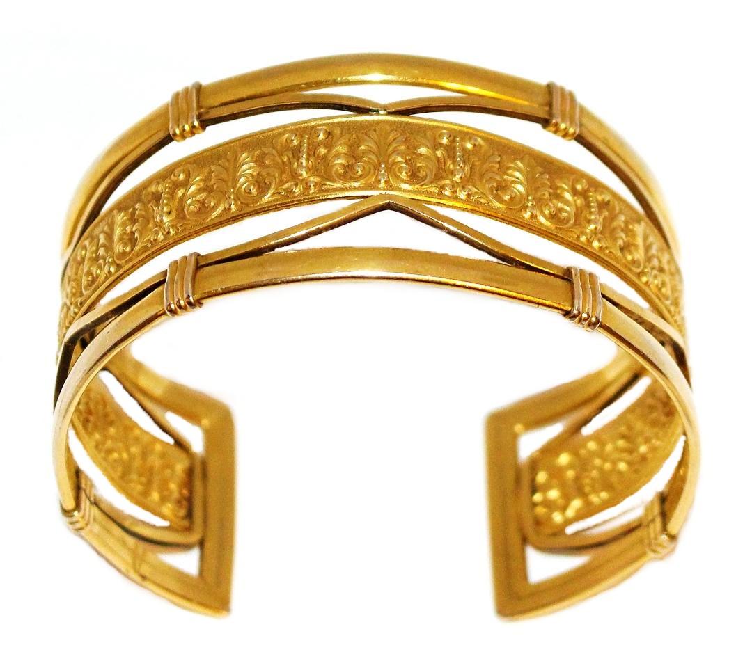 Circa 1930s to 1940s Krementz cuff with a heavy 14k gold overlay and an ornate motif covering the center strip.  It has a 7.35