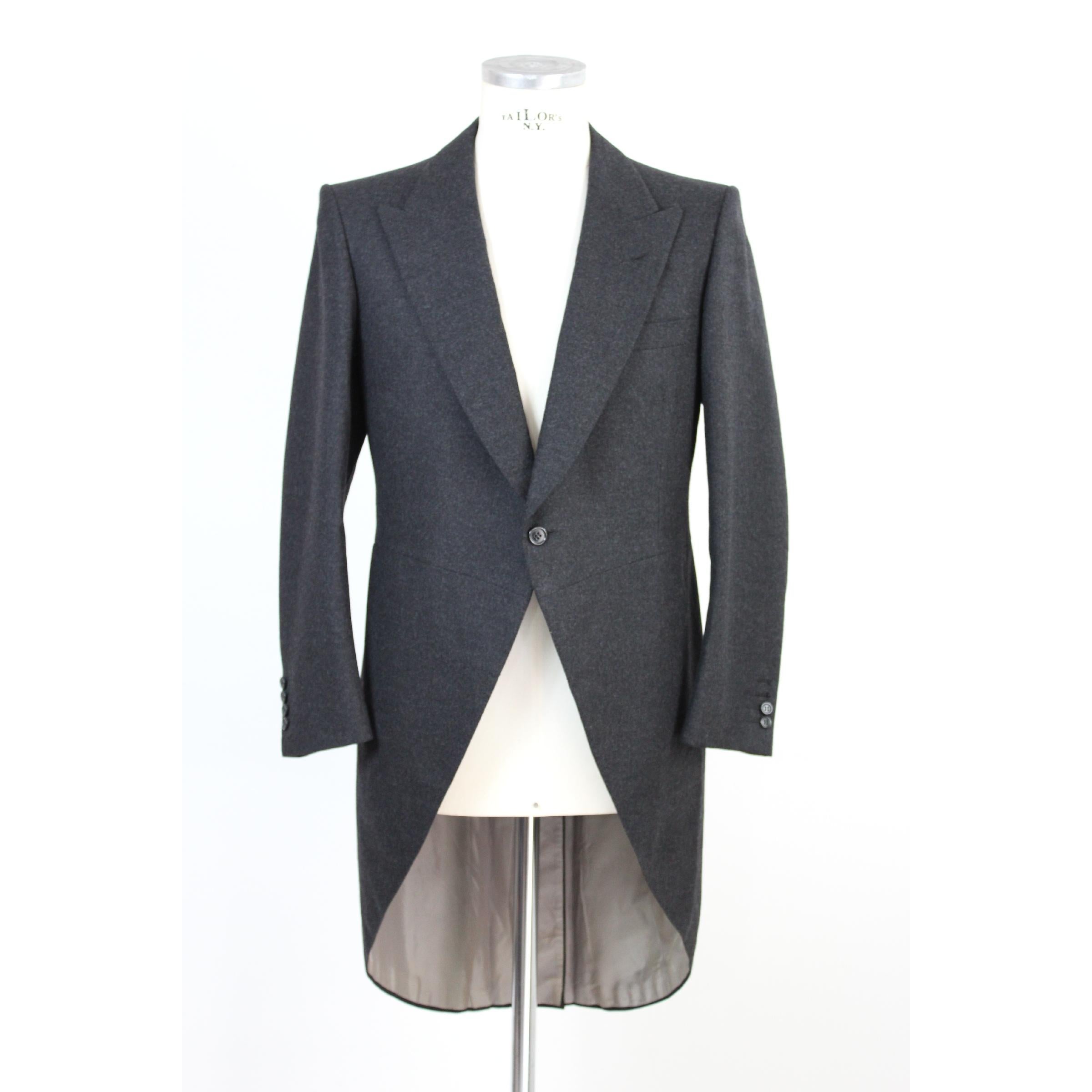 Brioni Roman Style, compost of three pieces. Dark gray color  jacket with long tails, waistcoat and trousers with two side pockets. The trousers have a fold on the hem. The color of the three pieces is different for everyone. Cortina model. Only the