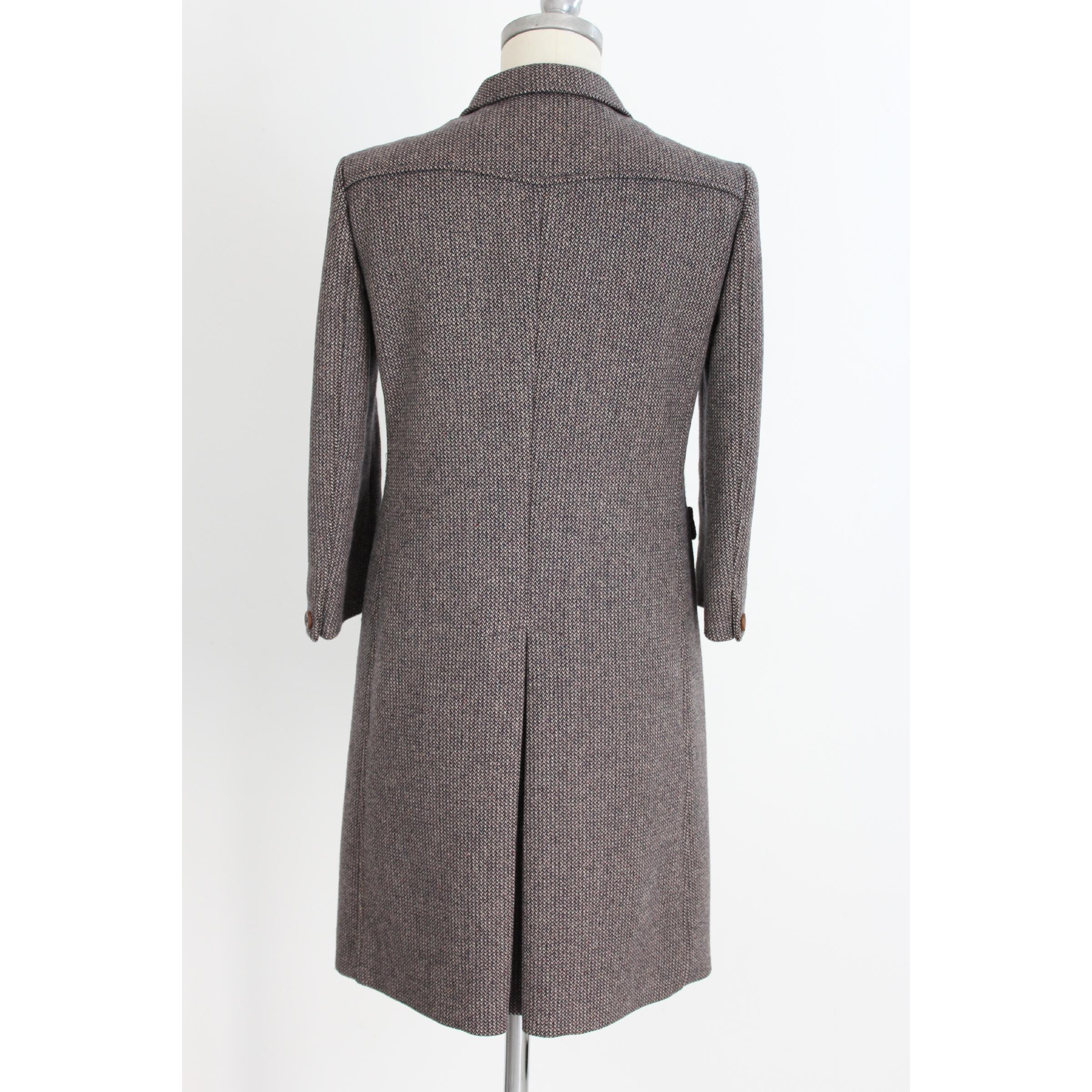 Miu Miu classic women's coat 2000s. Brown color in virgin wool, tweed fabric. There are two pockets on the sides, the sleeves are 3/4. All buttons are brown in 100% leather. Made in Italy. Excellent vintage conditions.

Size 40 It 6 Us 8