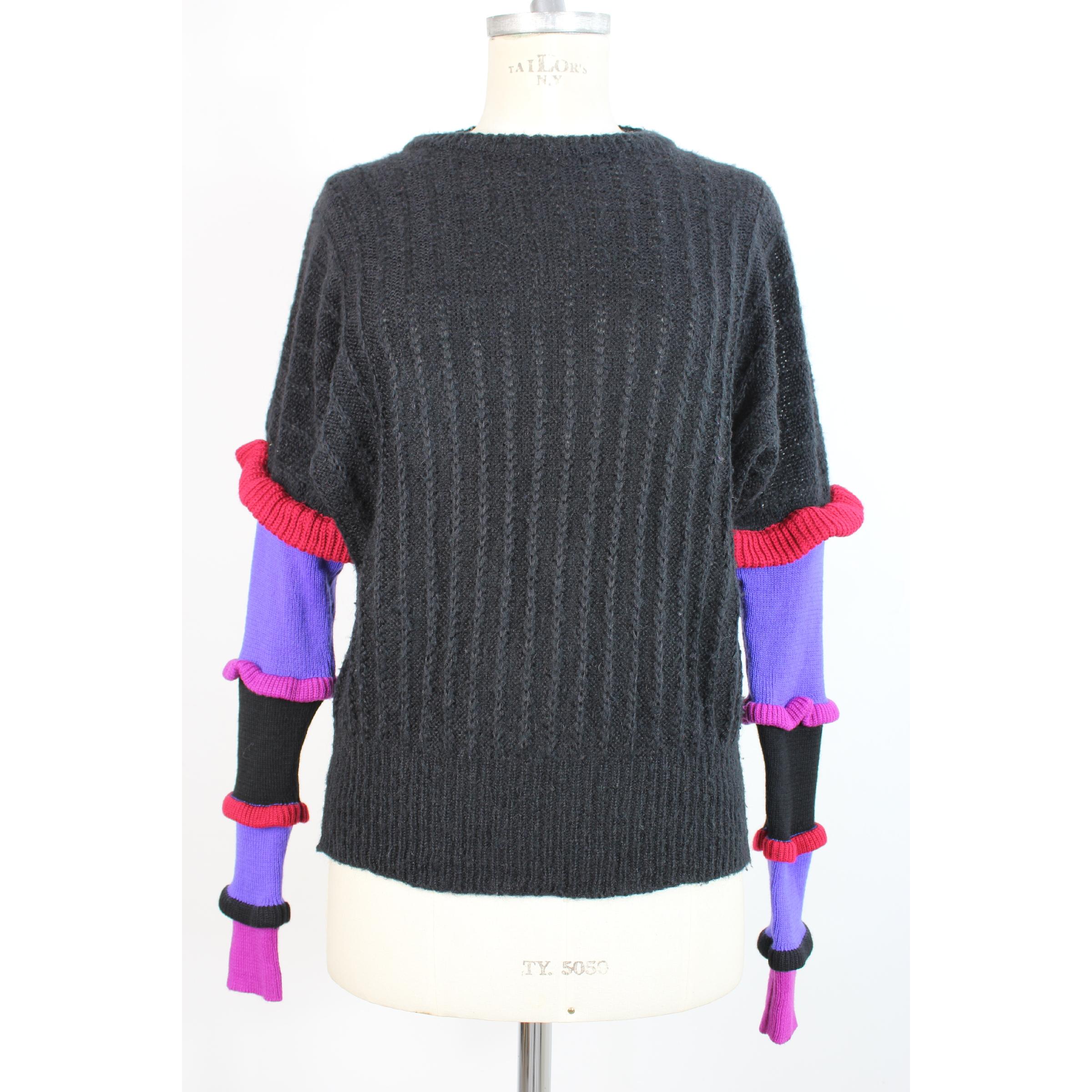 Vintage Roccobarocco women's sweater, black with colored sleeves, 35% wool 30% mohair 20% acrylic 15% poilamide. 1980s. Made in Italy. Good vintage conditions, previously owned and gently worn, with little signs of use. May show slight pilling,
