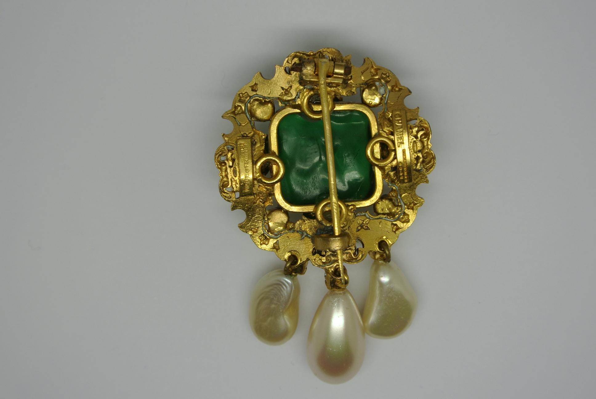 Most classic Chanel brooch, signature shows dated 1960s. Has been worn by Coco Chanel herself. It is in good condition. Designed by Robert Goossens, with poured glass.
