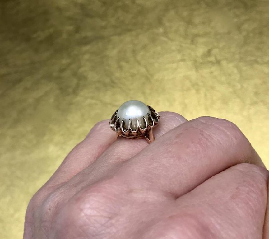This 1800s Victorian pearl ring is crafted with 10k rose gold plating and features a gorgeous 9.74mm natural pearl held in place with a unique, early Victorian, fancy multi prong setting. This unique antique pearl engagement ring would make an