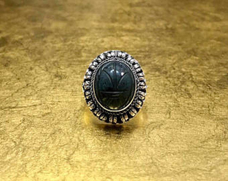 This antique scarab ring was crafted with 800 silver in the mid to late 1800s and features a detailed scarab beetle design carved in blue quartz (otherwise known as hawk eye or blue tigers eye). This unique Victorian ring features an interesting,