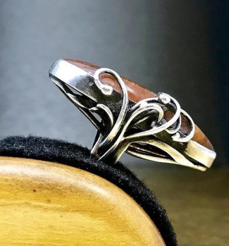 This unique amber ring is crafted with fine 950 sterling silver and features a very large piece of organic shaped, cabochon cut, amber. This unique silver ring would make a great vintage statement ring and the perfect birthday gift, anniversary