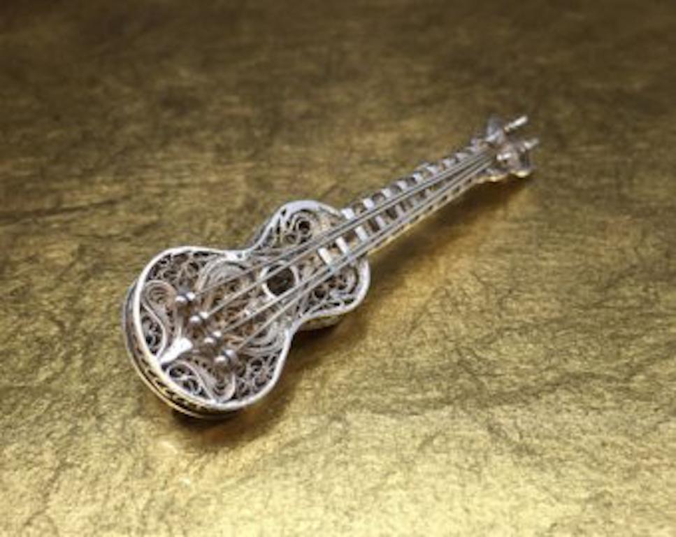 This antique musical brooch is crafted with 925 sterling silver and features a beautiful and intricately designed filigree violin. This vintage filigree brooch would make the perfect music teacher gift or a gift for that music lover in your life and