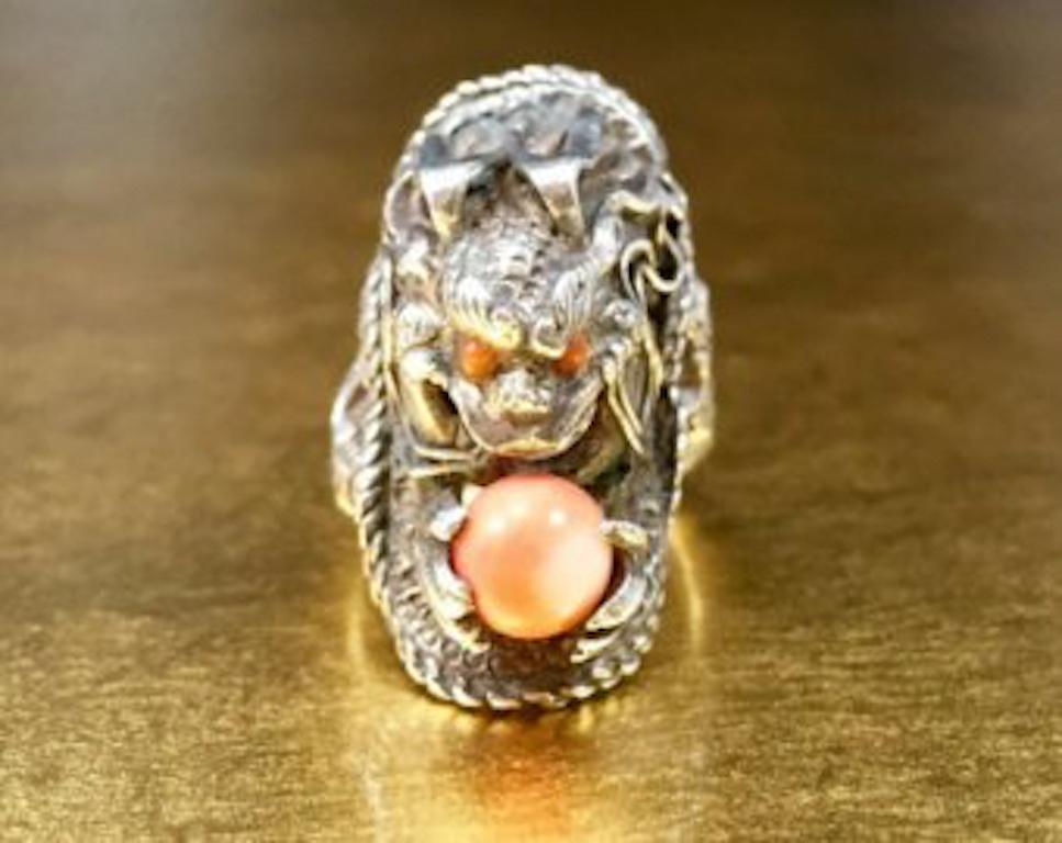 This intricate vintage dragon ring would be perfect for any collection. Crafted with 800 silver, this silver dragon ring features a coral accent, coral colored glass eyes, and an adjustable band. This vintage dragon statement ring would make an
