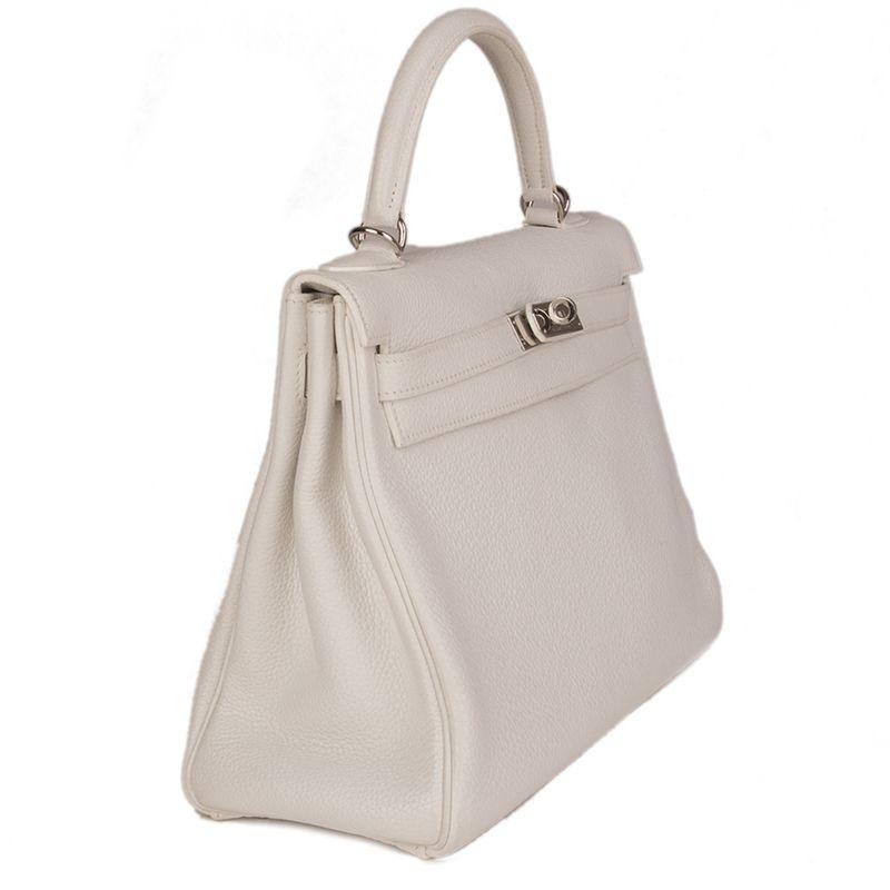 Hermes 'Kelly II 32 Retourner' bag in Blanc (white) Veau Togo leather with palladium hardware. The interior is lined in Chevre (goat skin) with a divided open pocket against the front and a zipper pocket against the back. Has been carried and is in
