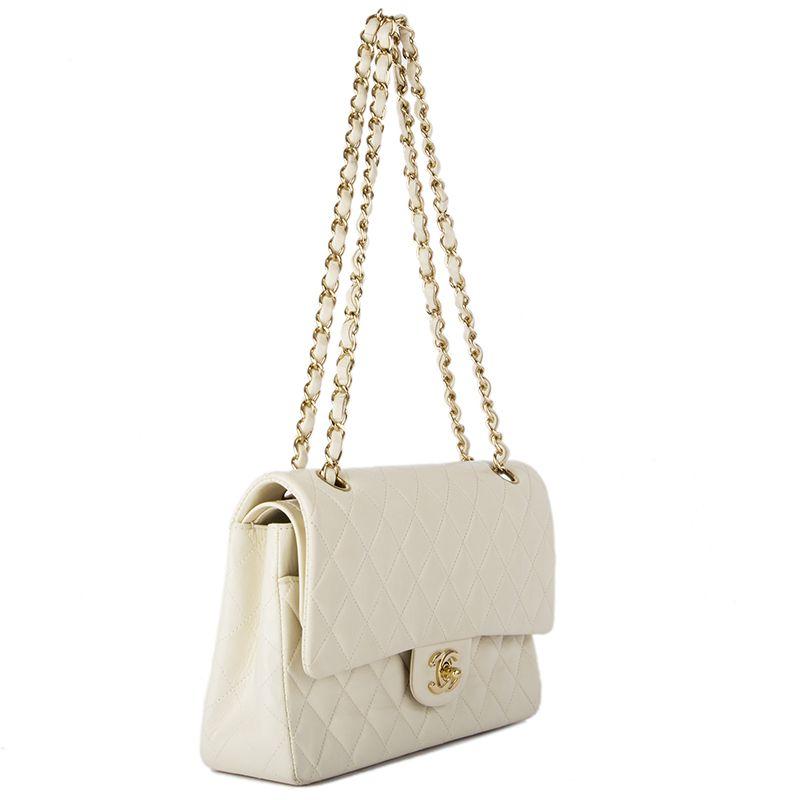 Chanel 'Timeless Classic Flap Medium' shoulder bag in off-white quilted leather. Open pocket on the back. Closes with classic CC-turn-lock on the front. Zipper pocket in the flap. Outside pocket on the front under the flap. Lined in off-white