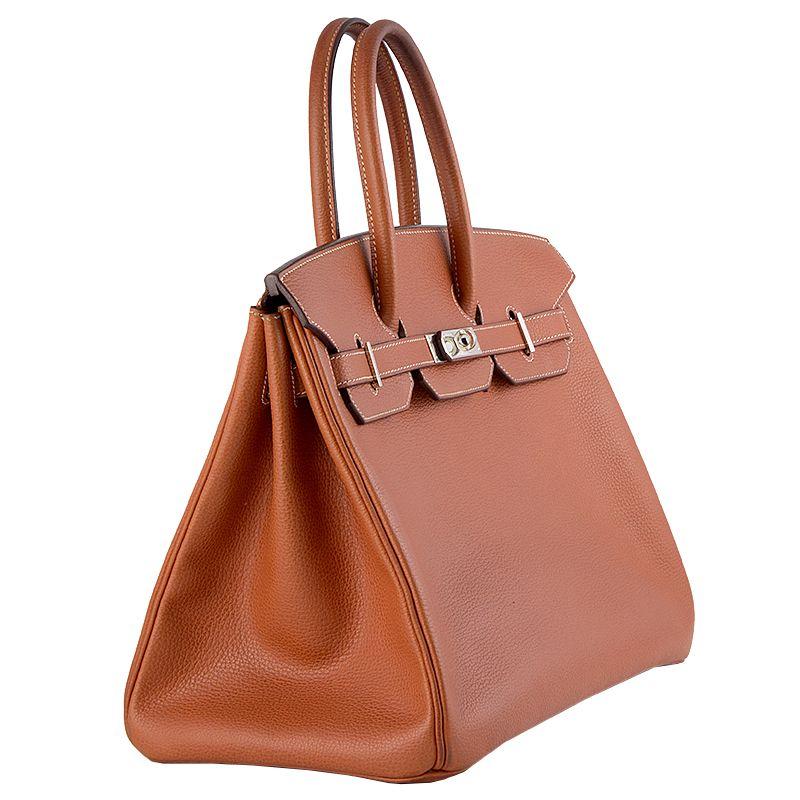 Hermes '35cm Birkin' bag in Brique (brick orange) Vache Liegee leather (grained, stiff) with contrasting white stitching. Lined in Chevre (goat skin) with an open pocket against the front and a zipper pocket against the back. Has been carried with