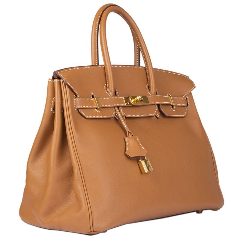 Hermes 'Birkin 35' in Gold (camel) Veau Swift leather (smooth) with contrasting white stiching. Lined in Gold Veau Swift with an open pocket against the front and a zipper pocket against back. Has been carried and is in excellent condition. Comes