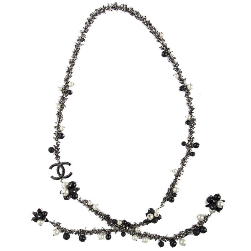 Chanel tie necklace in with black and off-white faux pearls and black beads. Signed Chanel on small round tag at the middle of the necklace. Has been carried and is in excellent condition. Comes with dust bag and box. 


